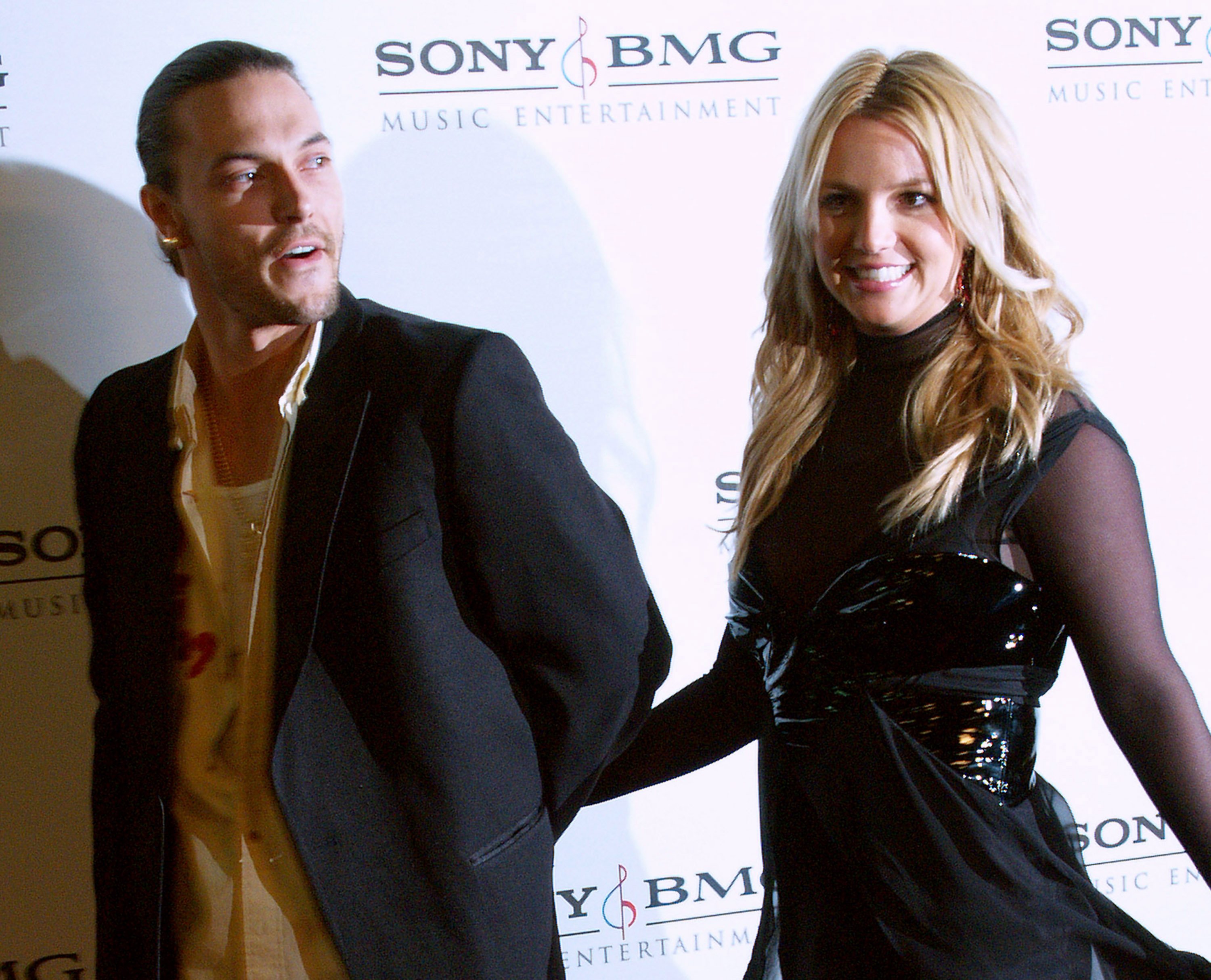 Britney Spears in a black dress, Kevin Federline in a black blazer and white shirt