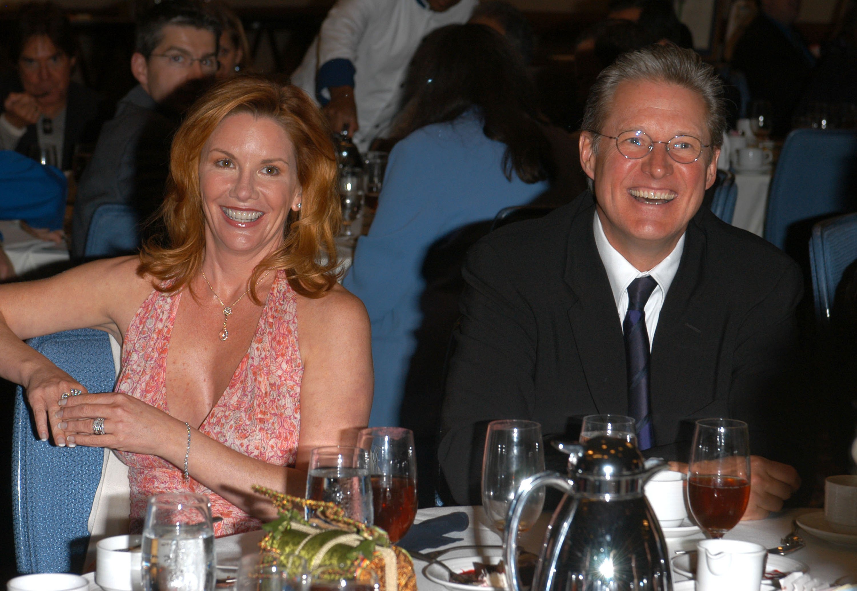 Melissa Gilbert in a pink dress, Bruce Boxleitner in a black suit.
