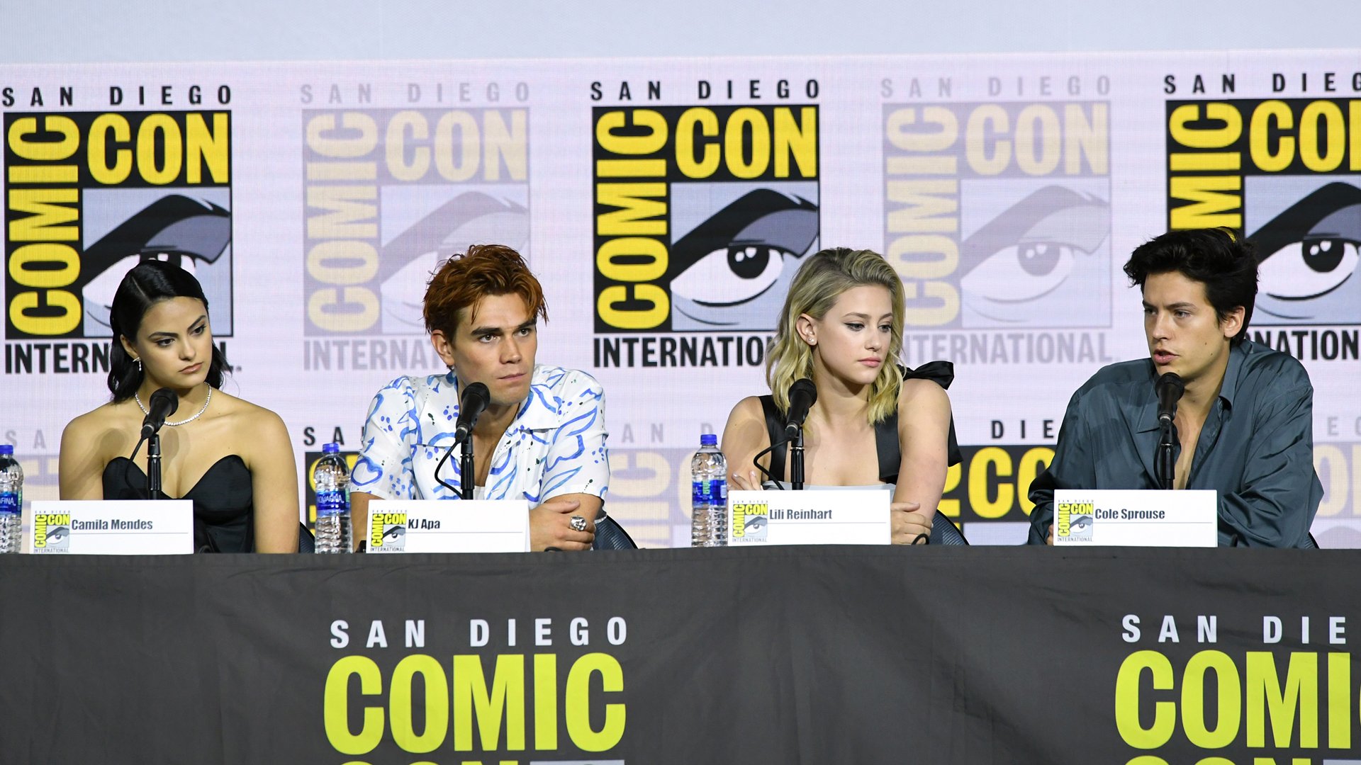 Camila Mendes, KJ Apa, Lili Reinhart, and Cole Sprouse speak at the "Riverdale" Special Video Presentation and Q&A during 2019 Comic-Con International at San Diego Convention Center on July 21, 2019 in San Diego, California. 
