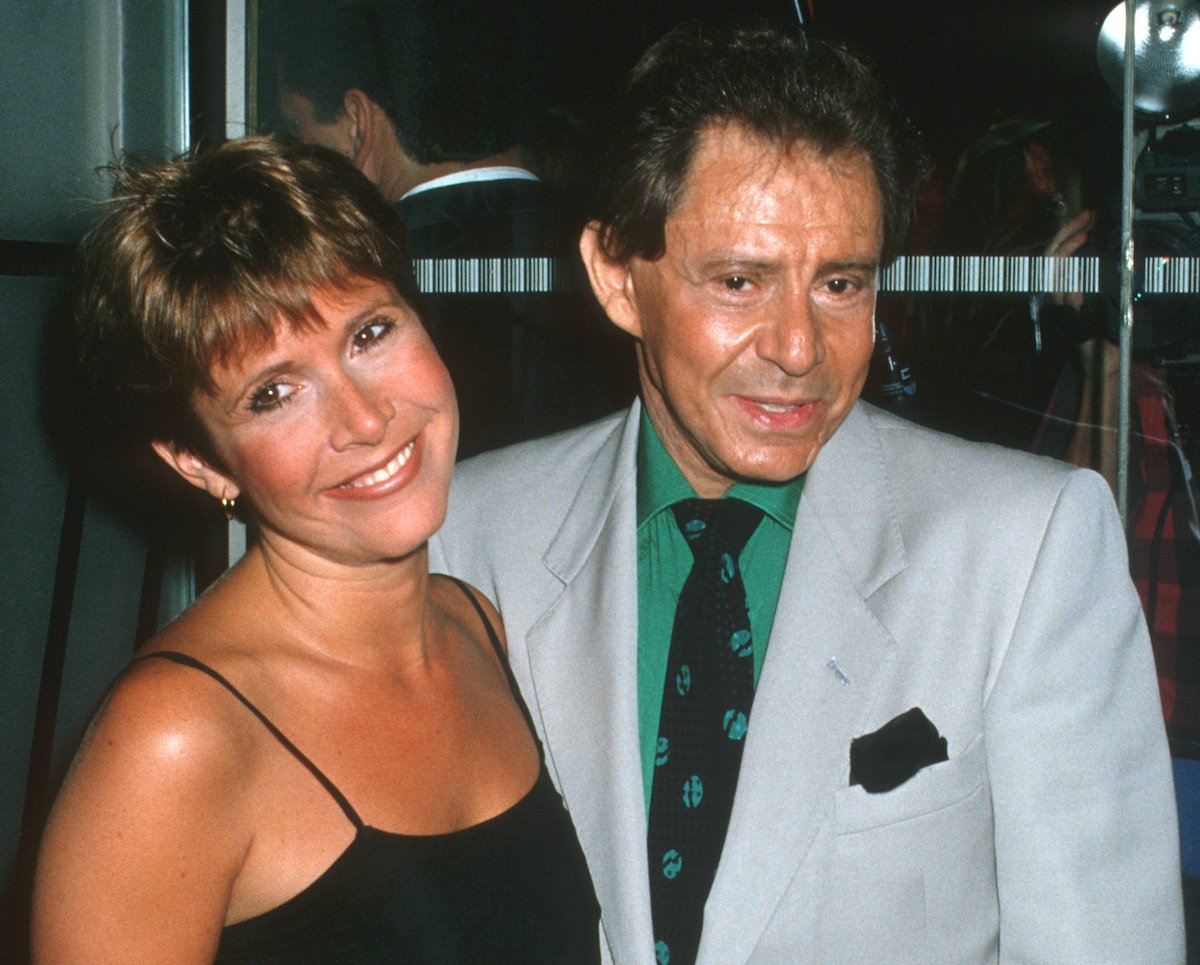 Carrie Fisher in a black dress and Eddie Fisher in a grey suit | Ron Galella/Ron Galella Collection via Getty Images