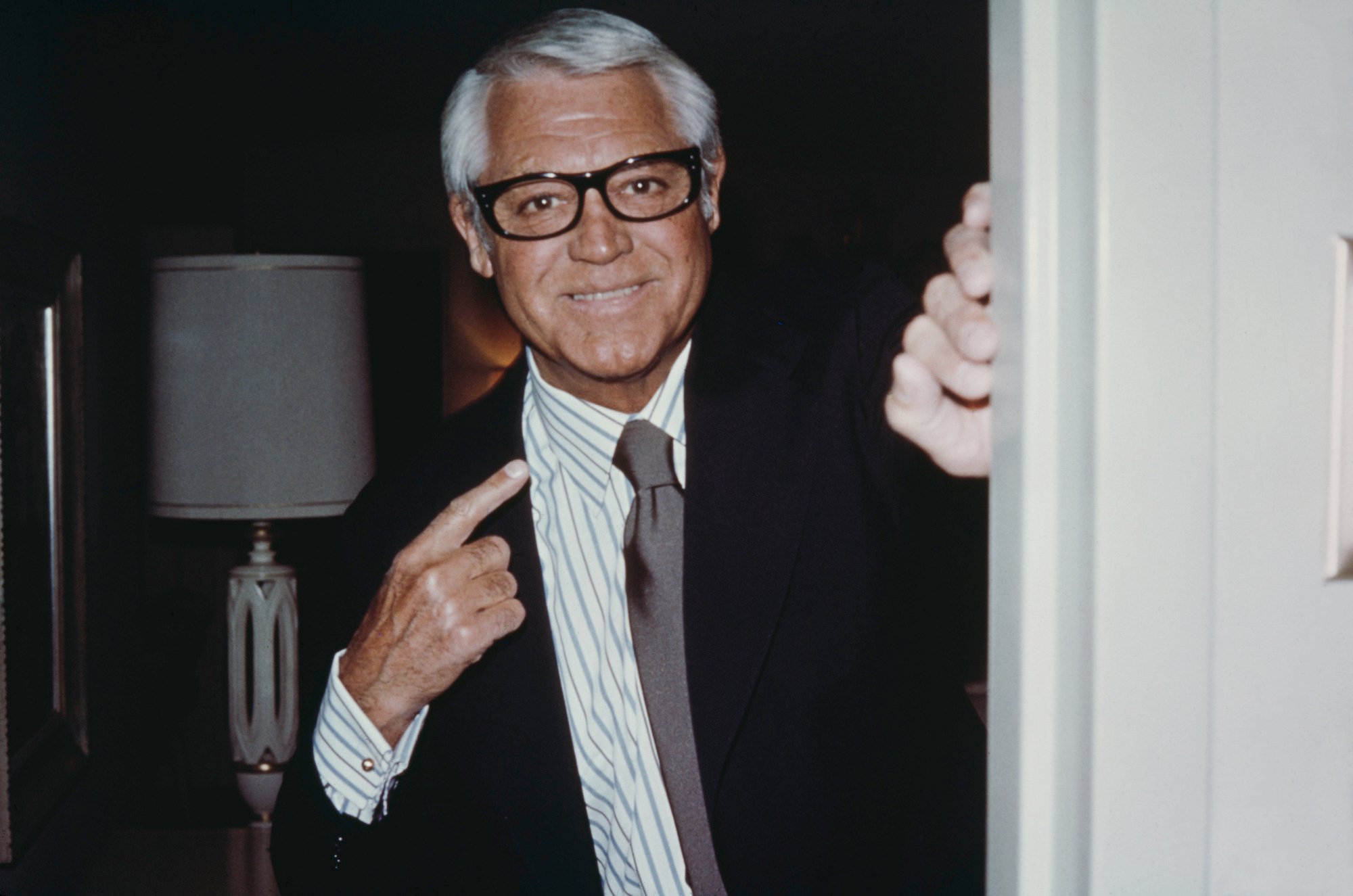Cary Grant smiling standing in a doorway