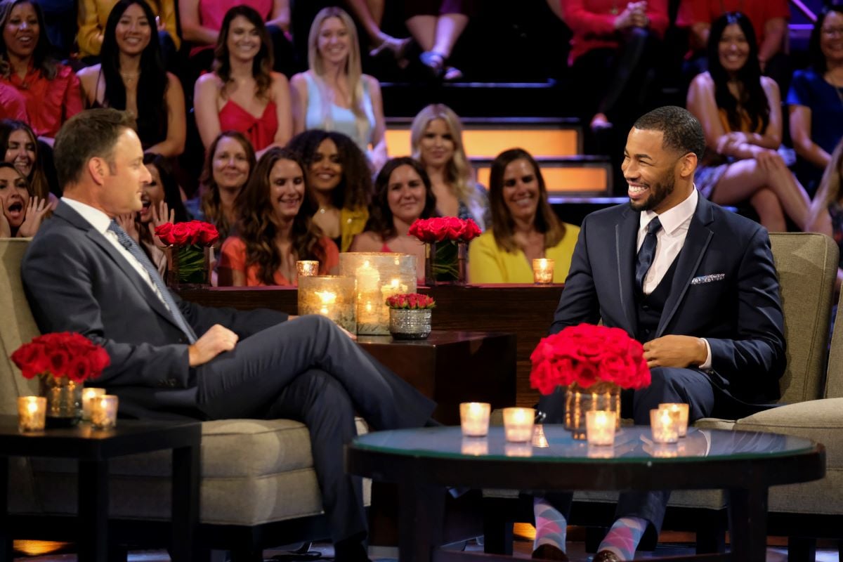 Chris Harrison and Mike Johnson sit onstage at the Men Tell All special of Hannah Brown's season of 'The Bachelorette'