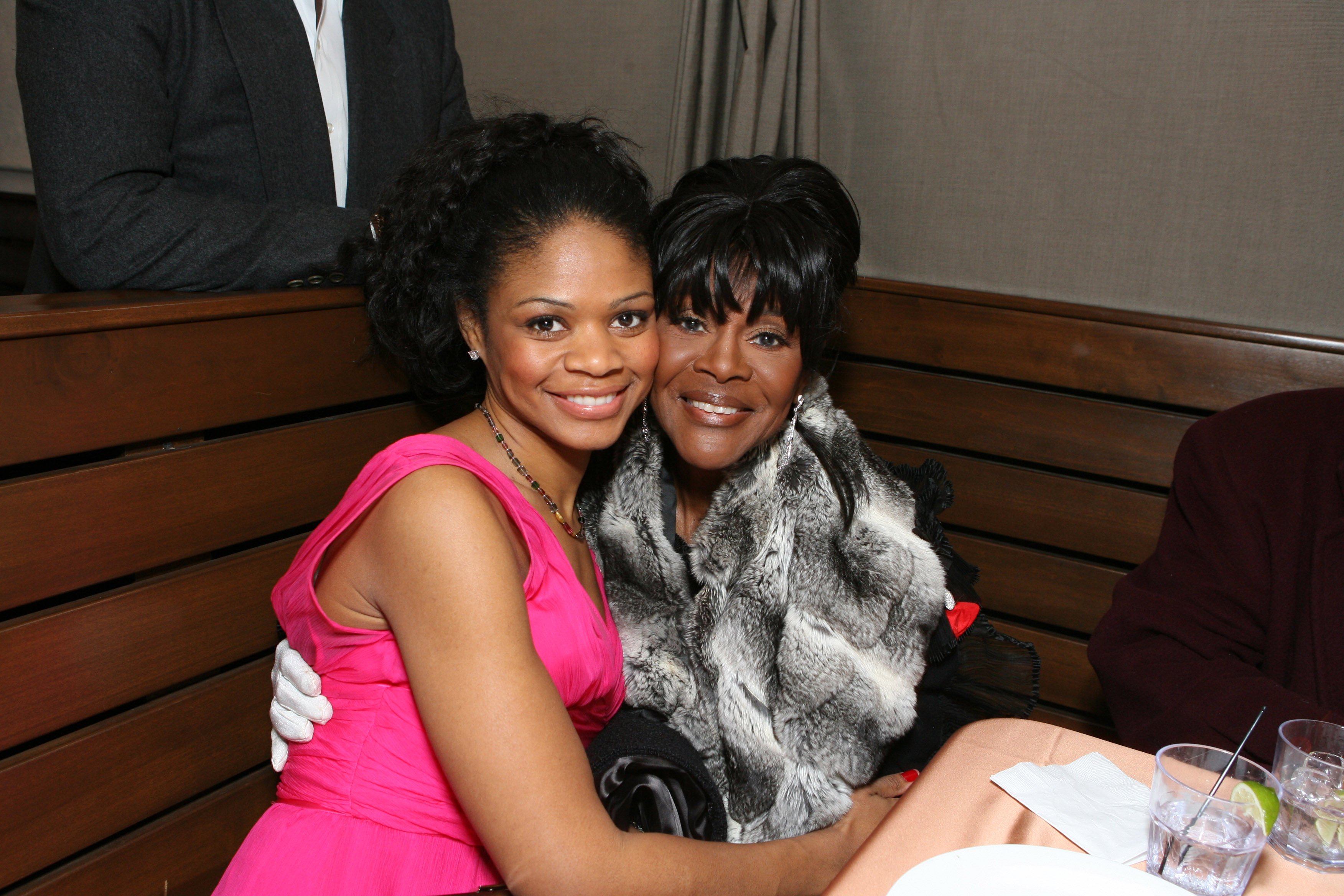 Kimberly Elise smiling in a pink dress/Cicely Tyson smiling in a fur coat.