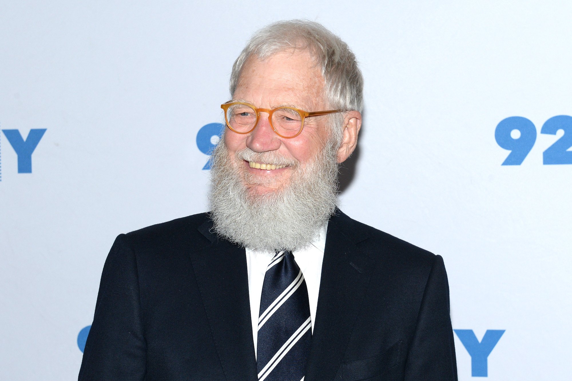 David Letterman smiling in front of a white background