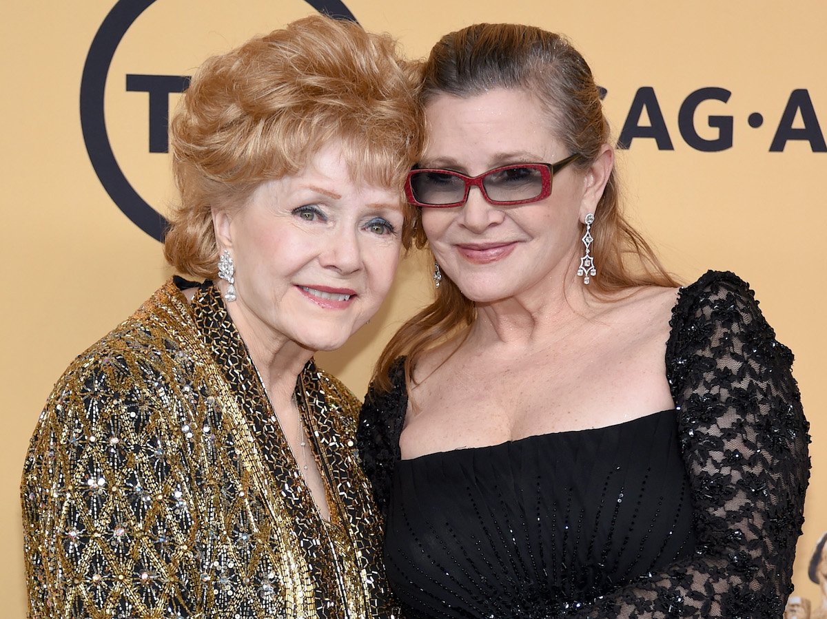 Debbie Reynolds and Carrie Fisher pose in the press room at the 21st Annual Screen Actors Guild Awards at The Shrine Auditorium on January 25, 2015 in Los Angeles, California | Ethan Miller/Getty Images