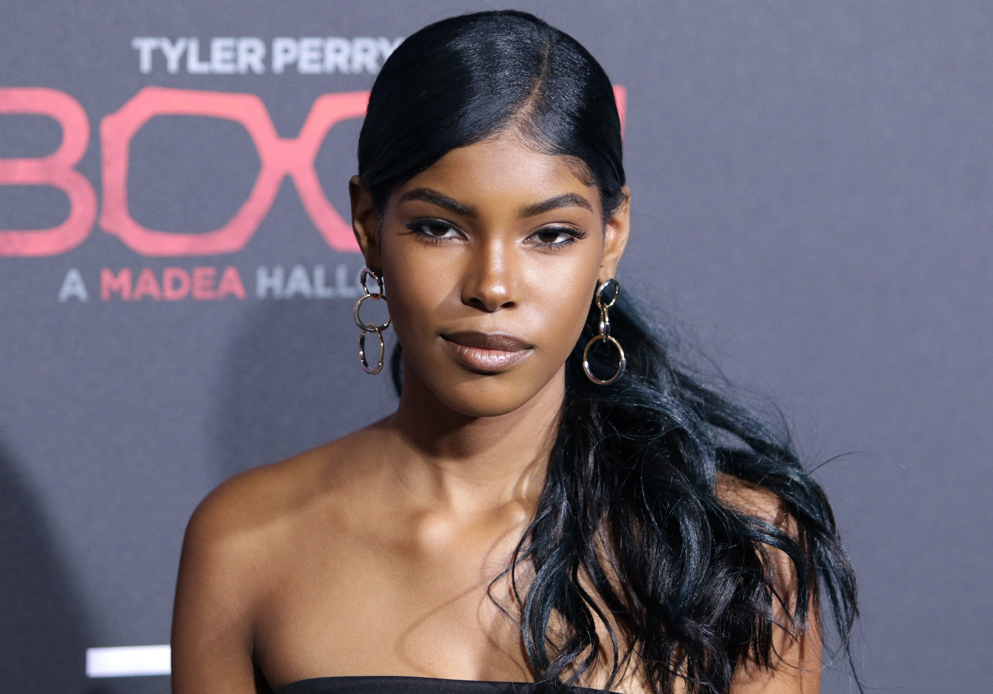 Diamond White smiling in front of a black background