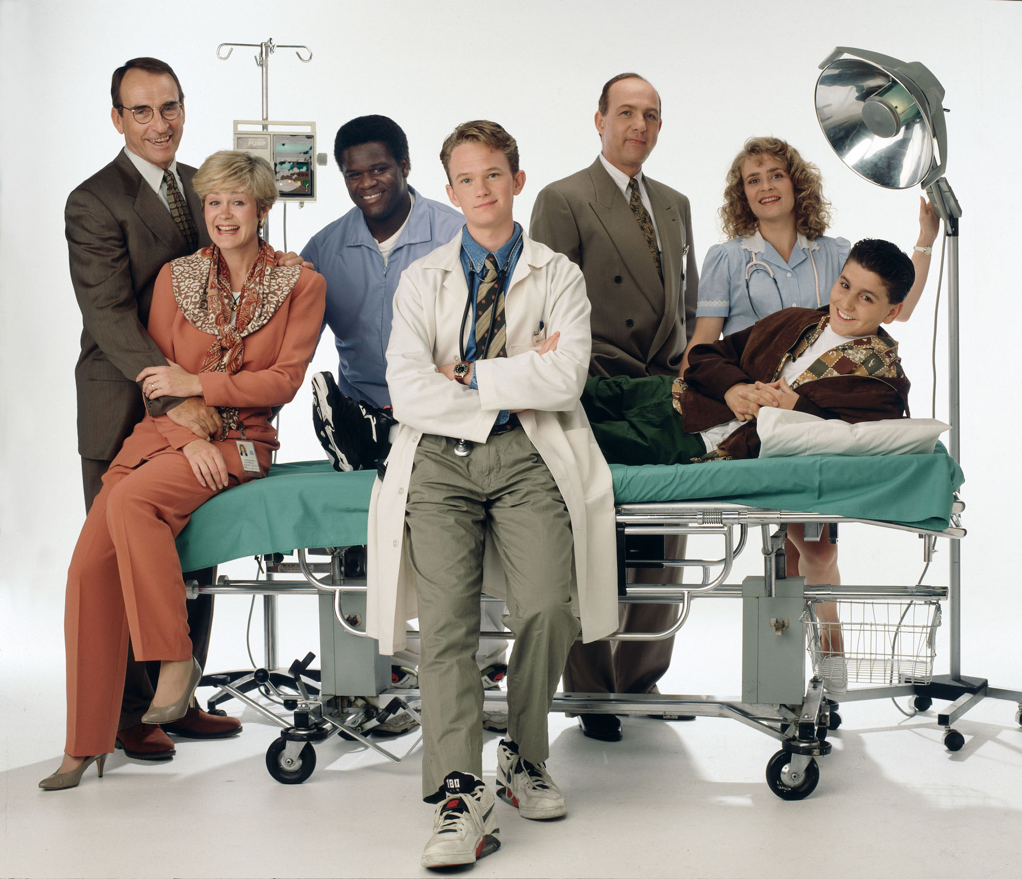 Cast of 'Doogie Howser, M.D.' gathered around a stretcher and medical lights