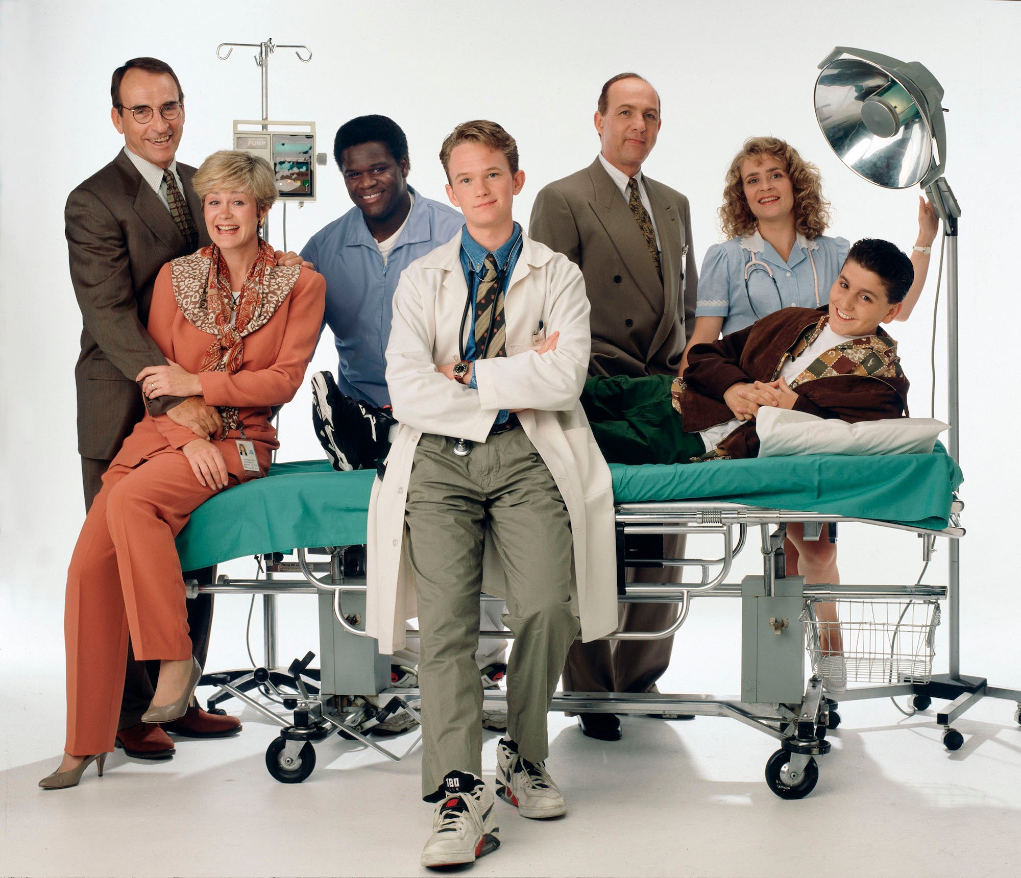 Cast of 'Doogie Howser, M.D.' gathered around a stretcher and medical lights