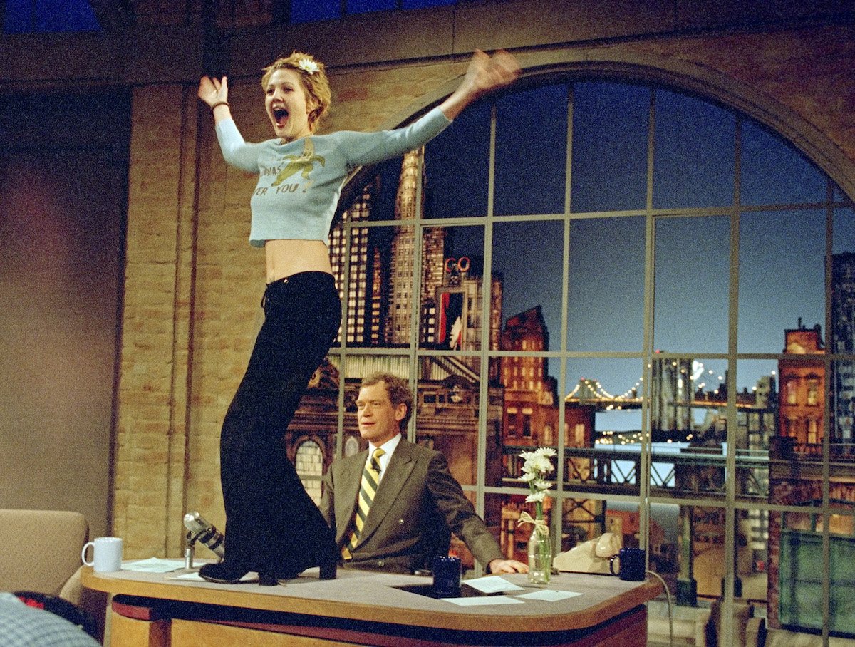 Drew Barrymore turns to the audience after flashing host David Letterman on 'The Late Show with David Letterman' in 1995