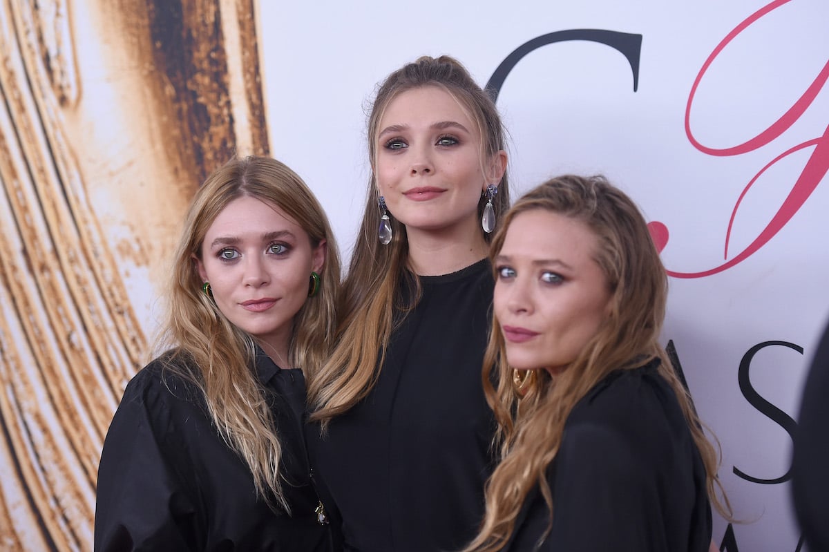 Elizabeth Olsen with her sisters Mary-Kate and Ashley Olsen at a red carpet event
