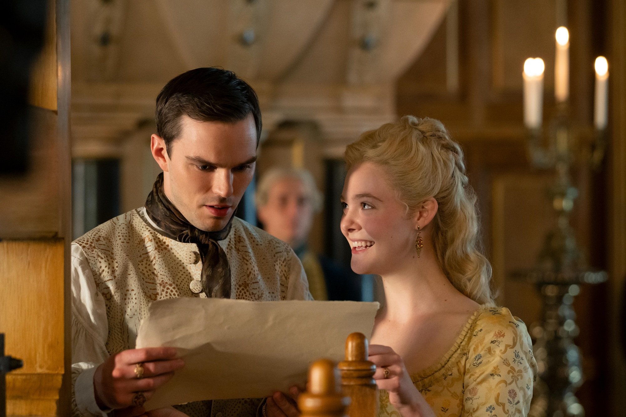 Elle Fanning and Nicolas Hoult with a letter on The Great