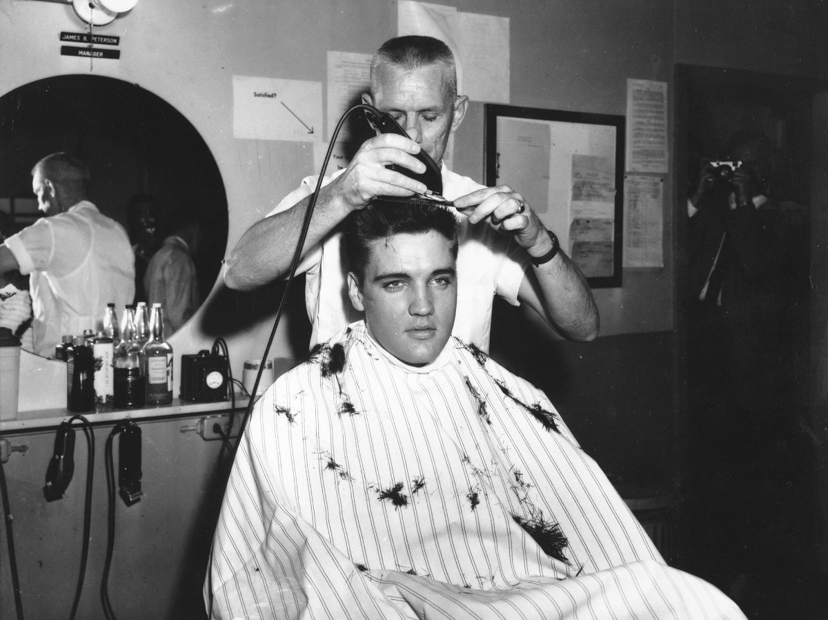 Elvis Presley at the barber getting a haircut as part of his stint in the U.S. Army in 1959
