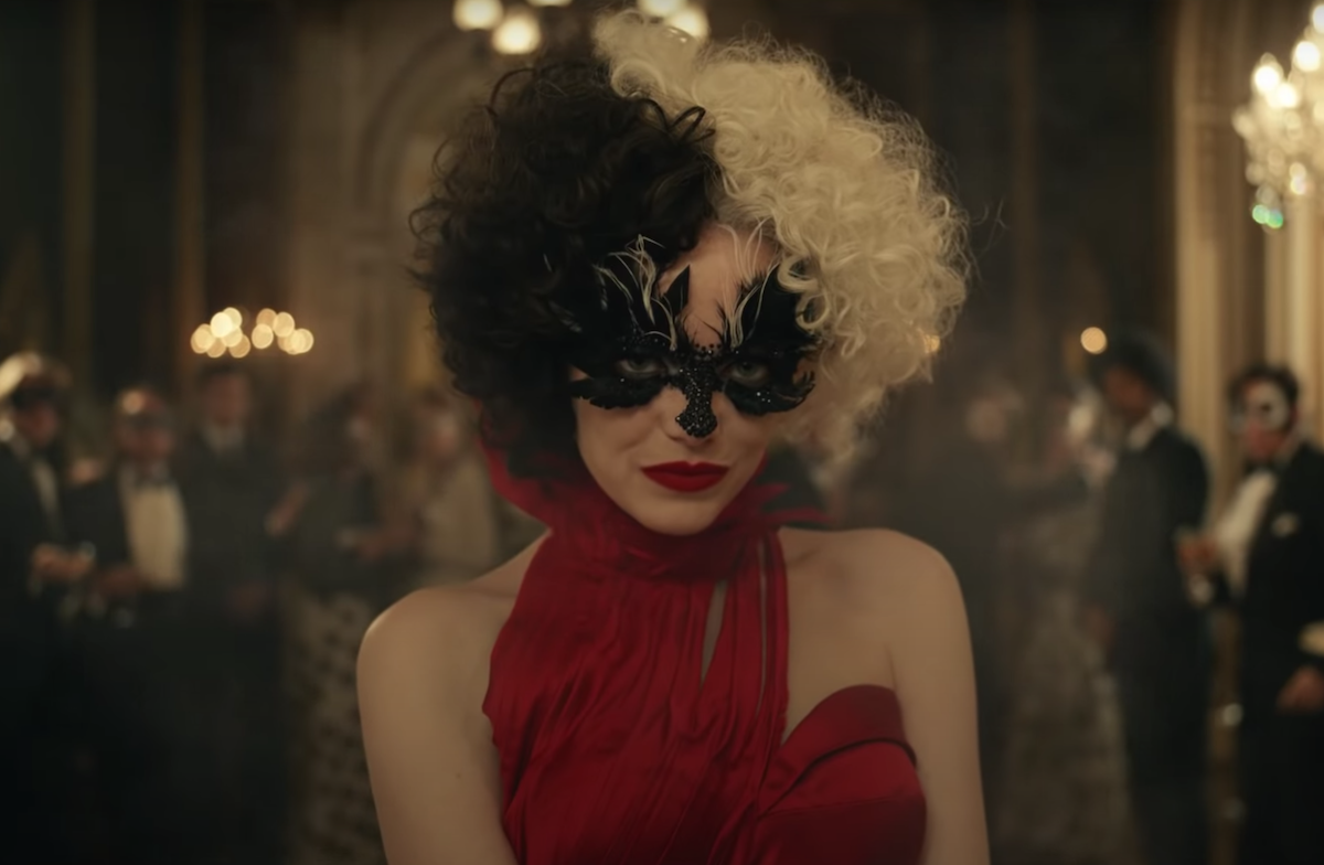 Emma Stone in a red dress and black eye mask as Cruella De Vil in the trailer for Disney's 'Cruella' | Disney