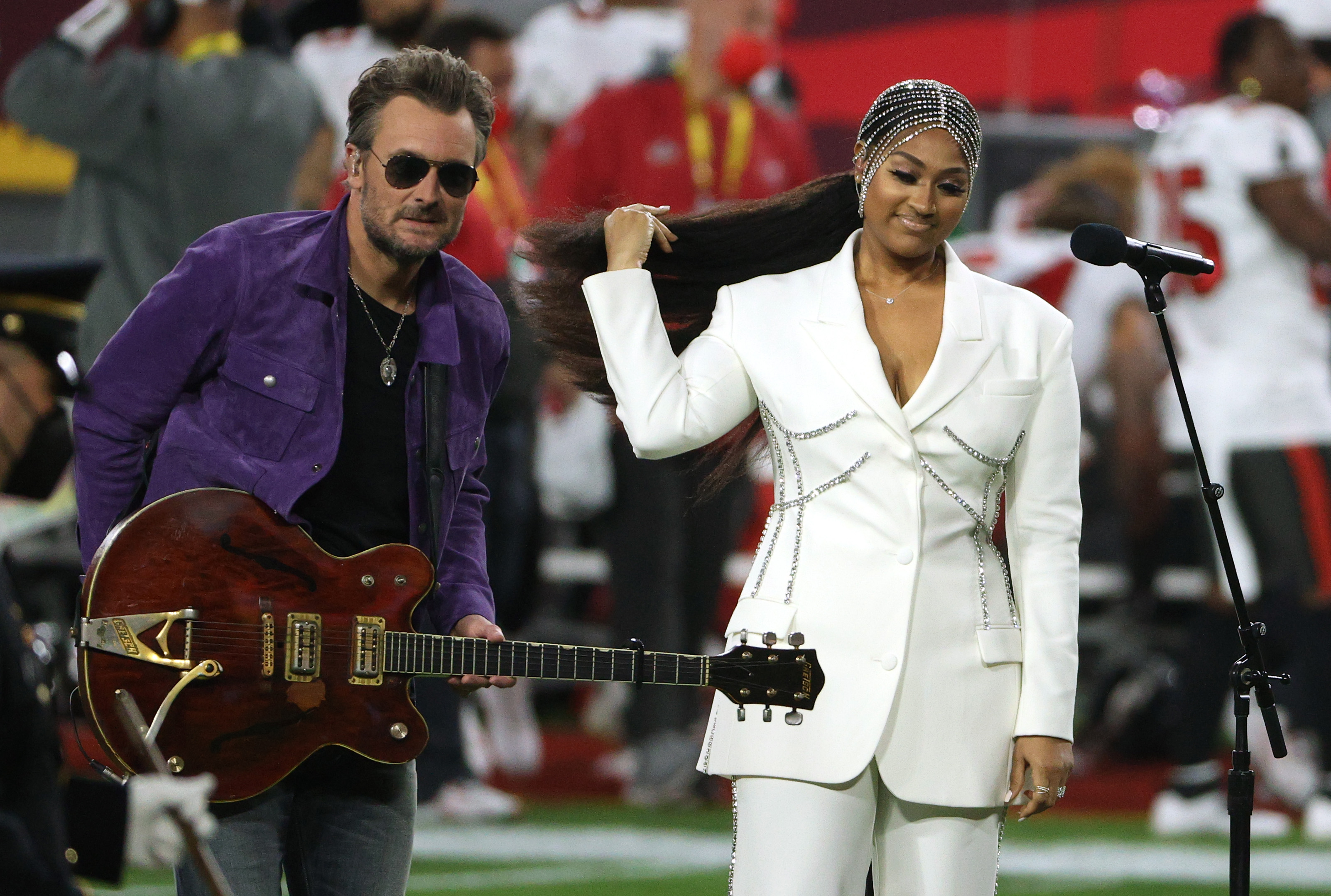 TAMPA, FLORIDA - FEBRUARY 07: Jazmine Sullivan and Eric Church perform the national anthem before Super Bowl LV between the Tampa Bay Buccaneers and the Kansas City Chiefs at Raymond James Stadium on February 07, 2021 in Tampa, Florida.