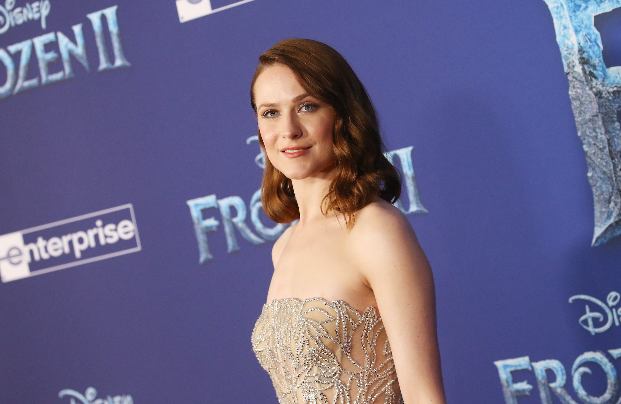 Evan Rachel Wood smiling in front of a purple background