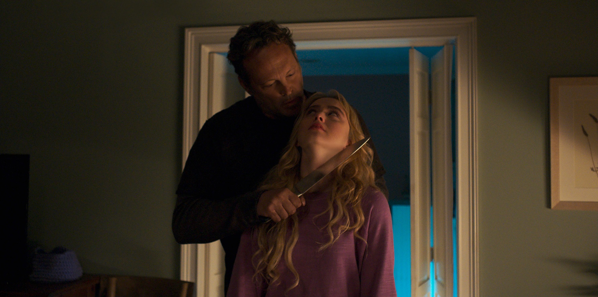 Freaky star Vince Vaughn holding Kathryn Newton at knifepoint