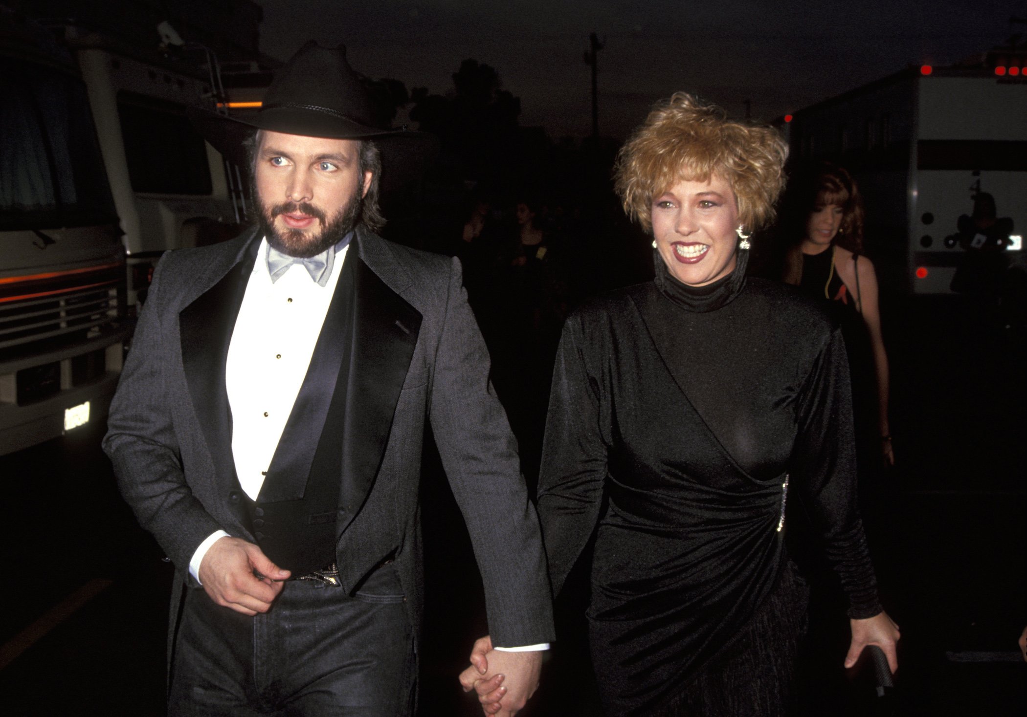 Garth Brooks and wife Sandy Mahl walking hand in hand at an awards show