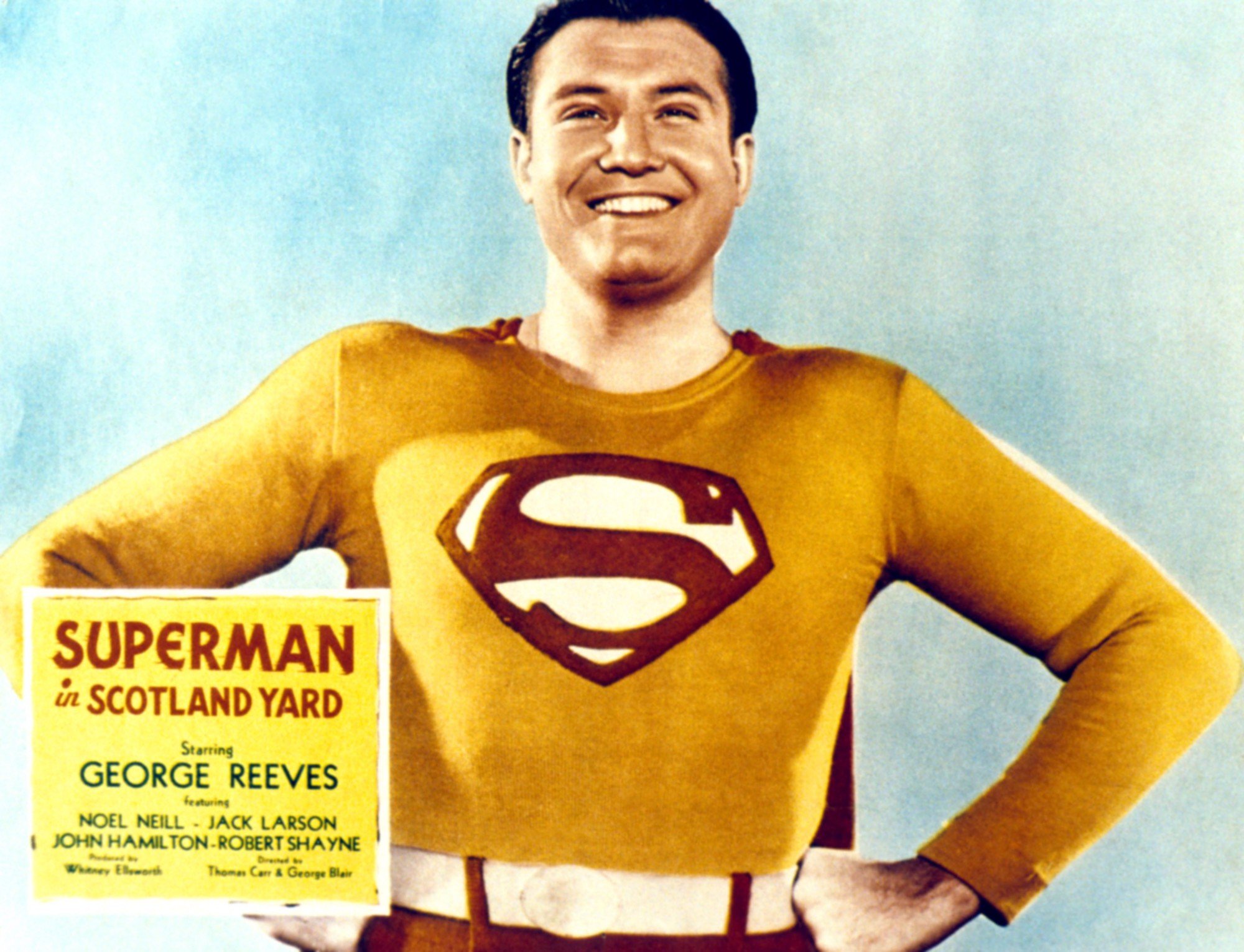 George Reeves as Superman with his hands on his hips on a promotional poster