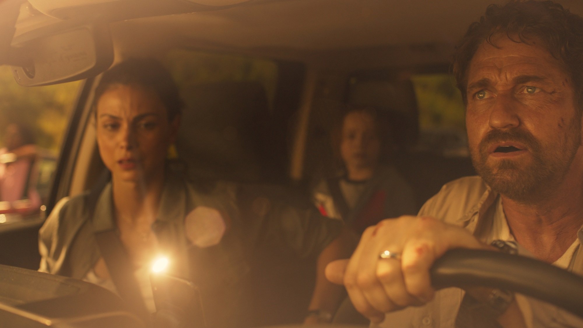 Gerard Butler, Morena Baccarin and Roger Dale Floyd drive together in a car