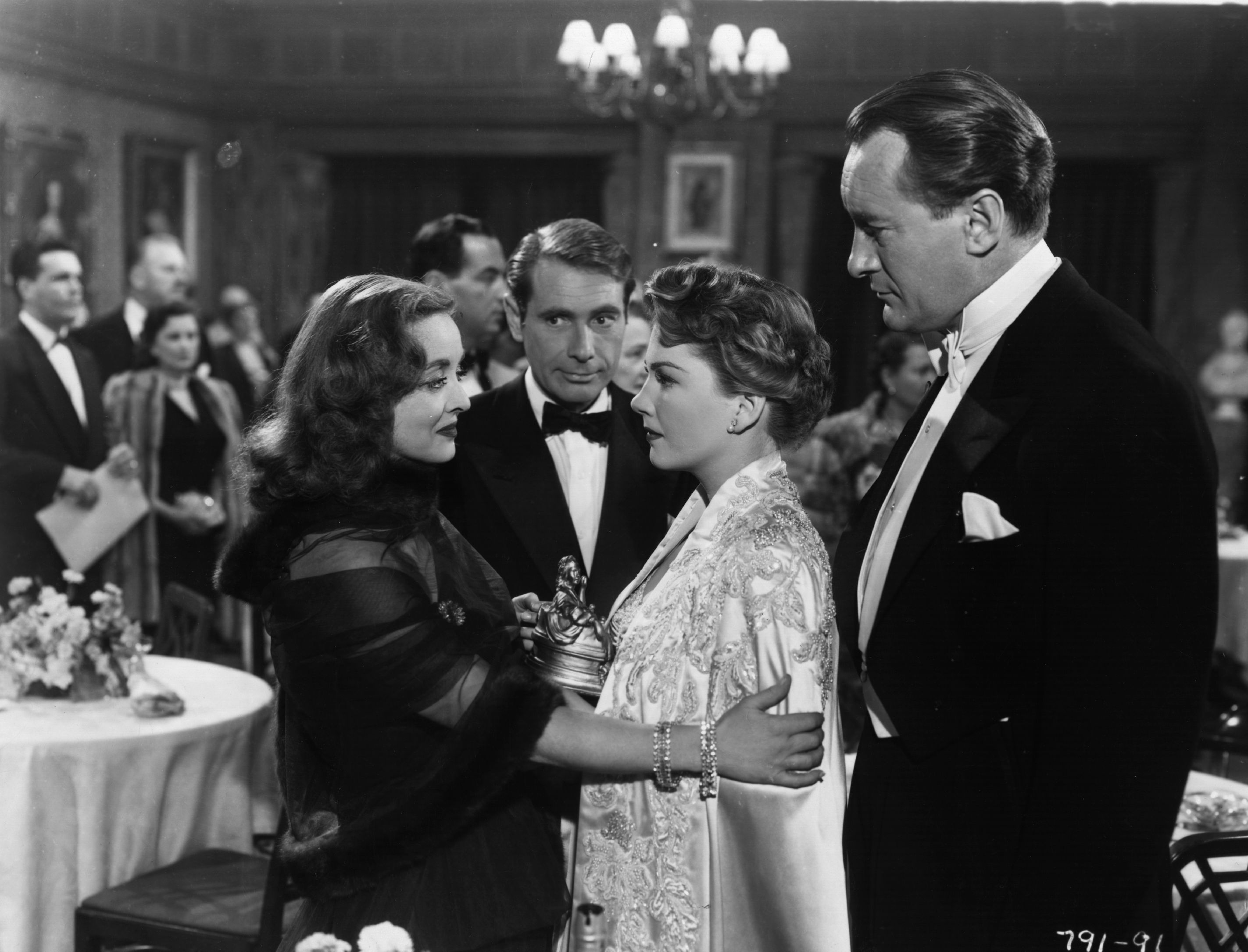 (L to R): Bette Davis, Gary Merrill, Anne Baxter, and George Sanders in a scene from 'All About Eve'