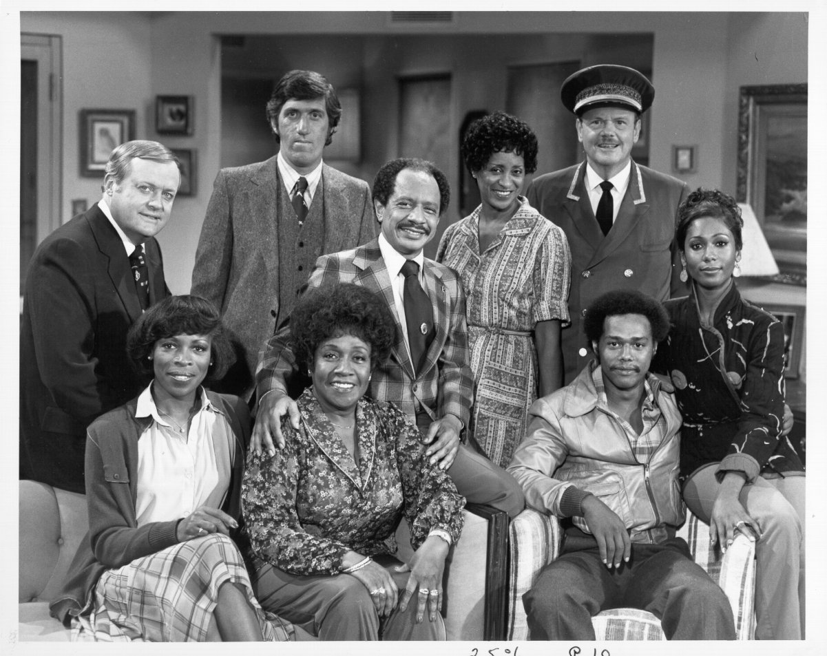 The cast of the TV sitcom 'The Jeffersons' (L-R Back Row: Franklin Cover, Paul Benedict, Sherman Hemsley, Marla Gibbs, Ned Wertimer and Berlinda Tolbert, Front Row, seated: Roxie Roker, Isabel Sanford, and Mike Evans circa 1975