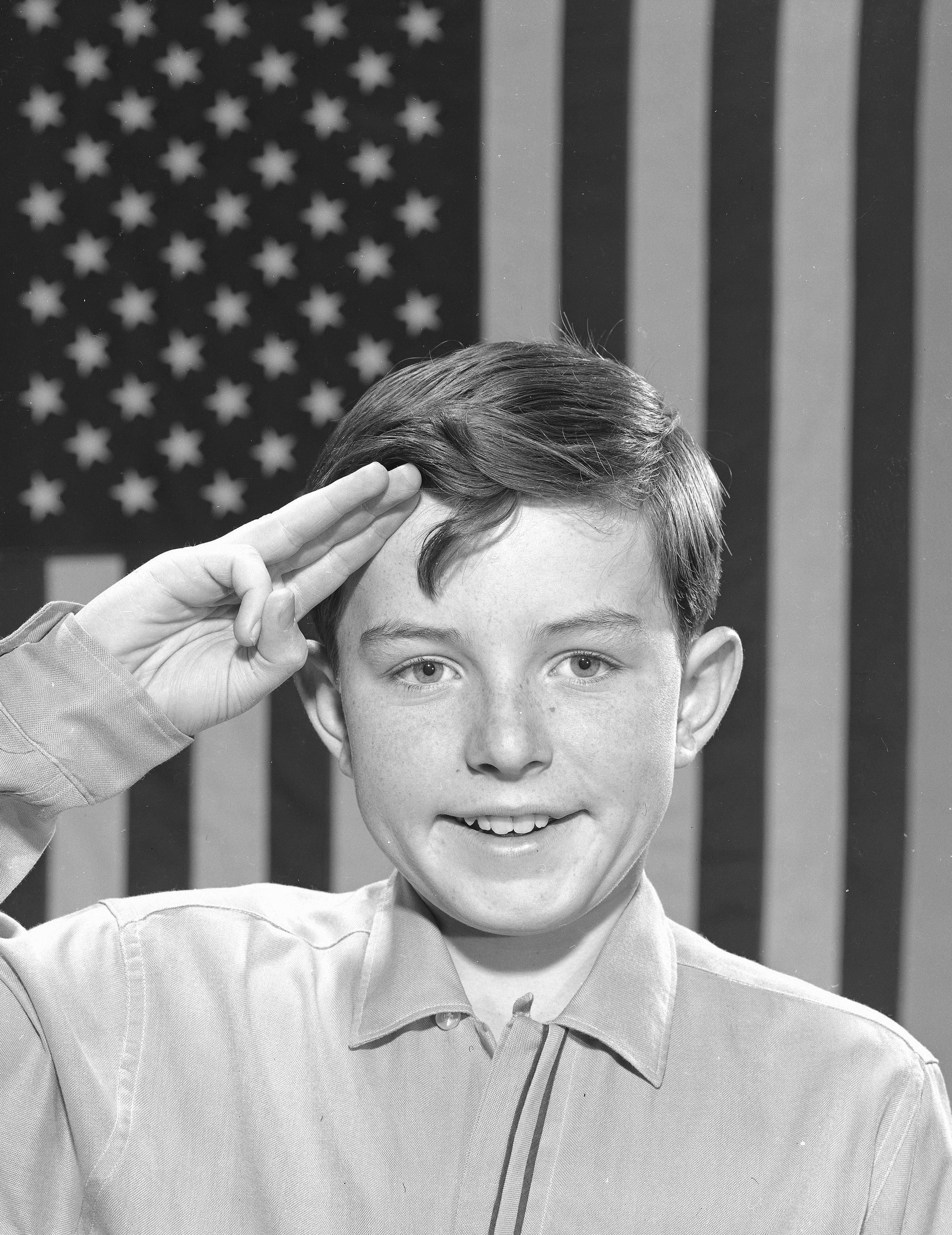 'Leave It to Beaver' star Jerry Mathers saluting the flag, 1961