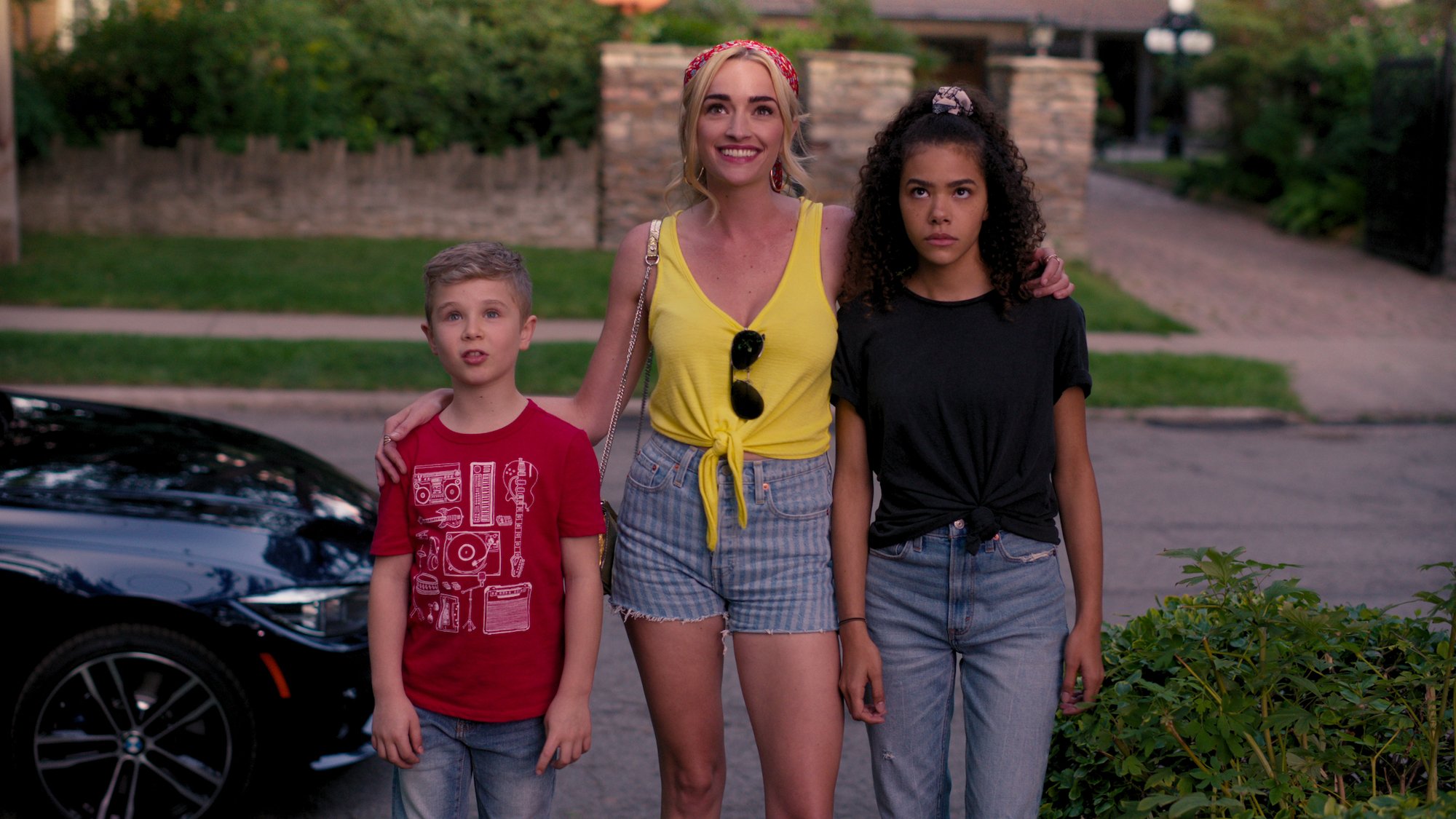 (L-R) Diesel La Torraca as Austin, Brianne Howey as Georgia, and Antonia Gentry as Ginny standing in front of a street