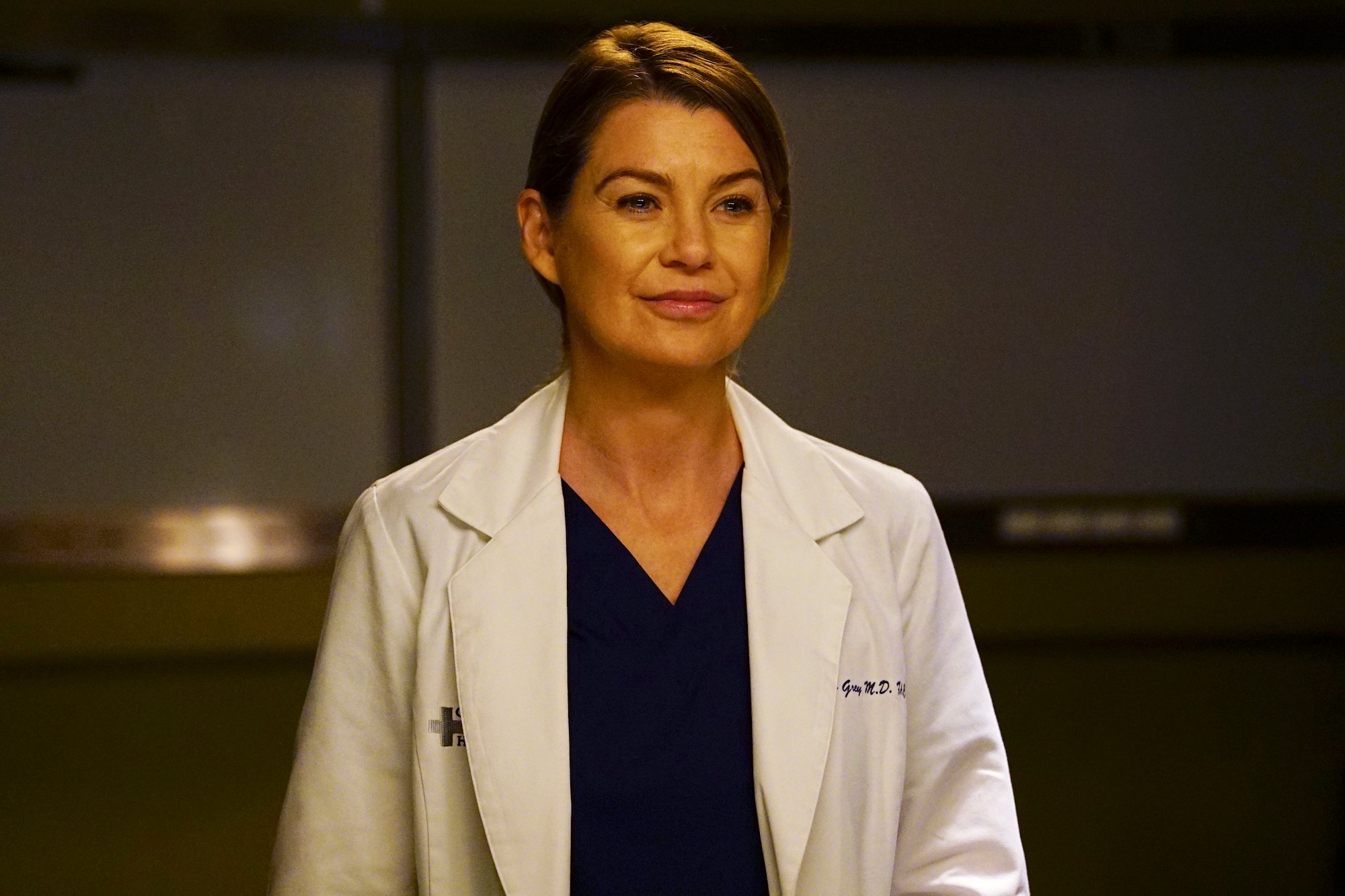 Ellen Pompeo as Meredith Grey smiling in front of a blurred background