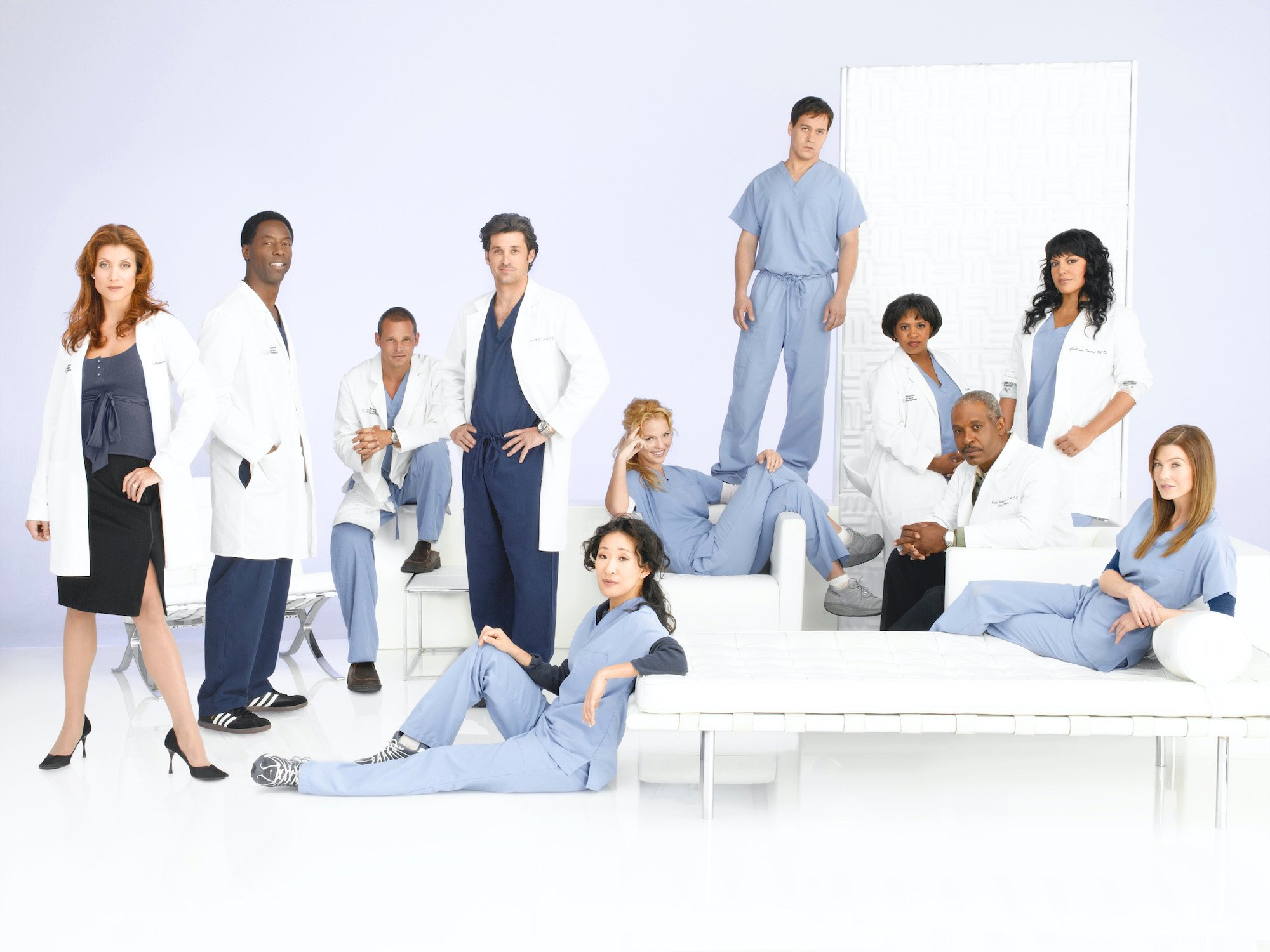 (L-R) Kate Walsh as Addison Shepherd, Isaiah Washington as Preston Burke, Justin Chambers as Alex Karev, Patrick Dempsey as Derek Shepherd, Sandra Oh as Cristina Yang, Katherine Heigl as Isobel "Izzie" Stevens, T.R. Knight as George O'Malley, Chandra Wilson as Miranda Bailey, James Pickens, Jr. as Richard Webber, Sara Ramirez as Dr. Callie Torres and Ellen Pompeo as Meredith Grey in medical garb in front of a white background