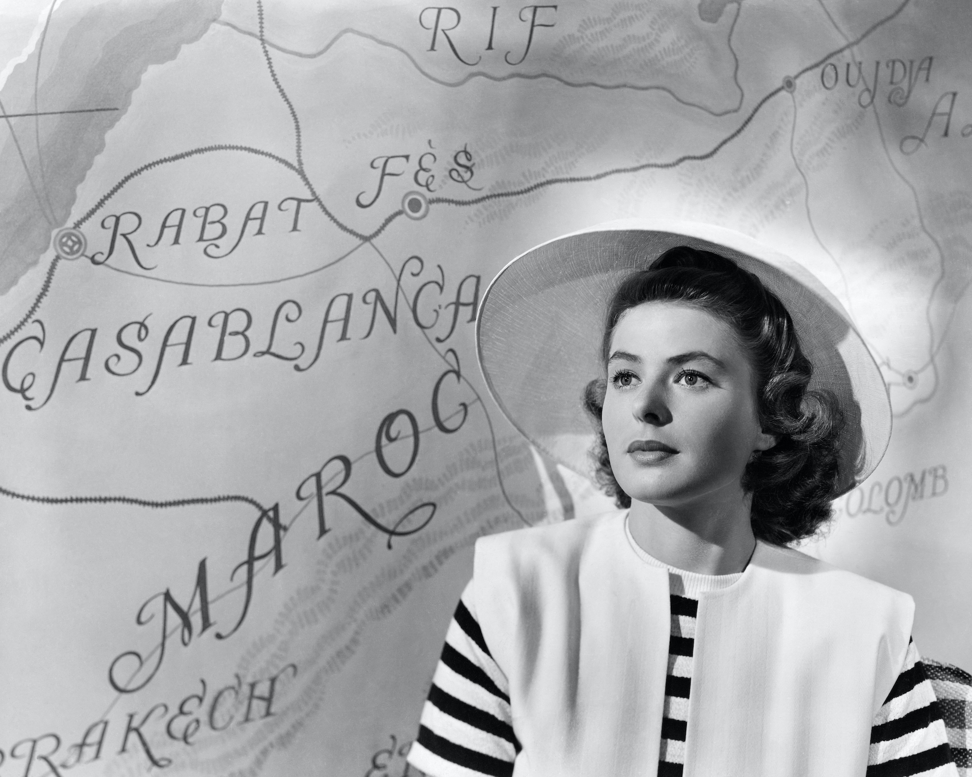 Ingrid Bergman in Casablanca, sitting in front of a map looking off camera, in black and white