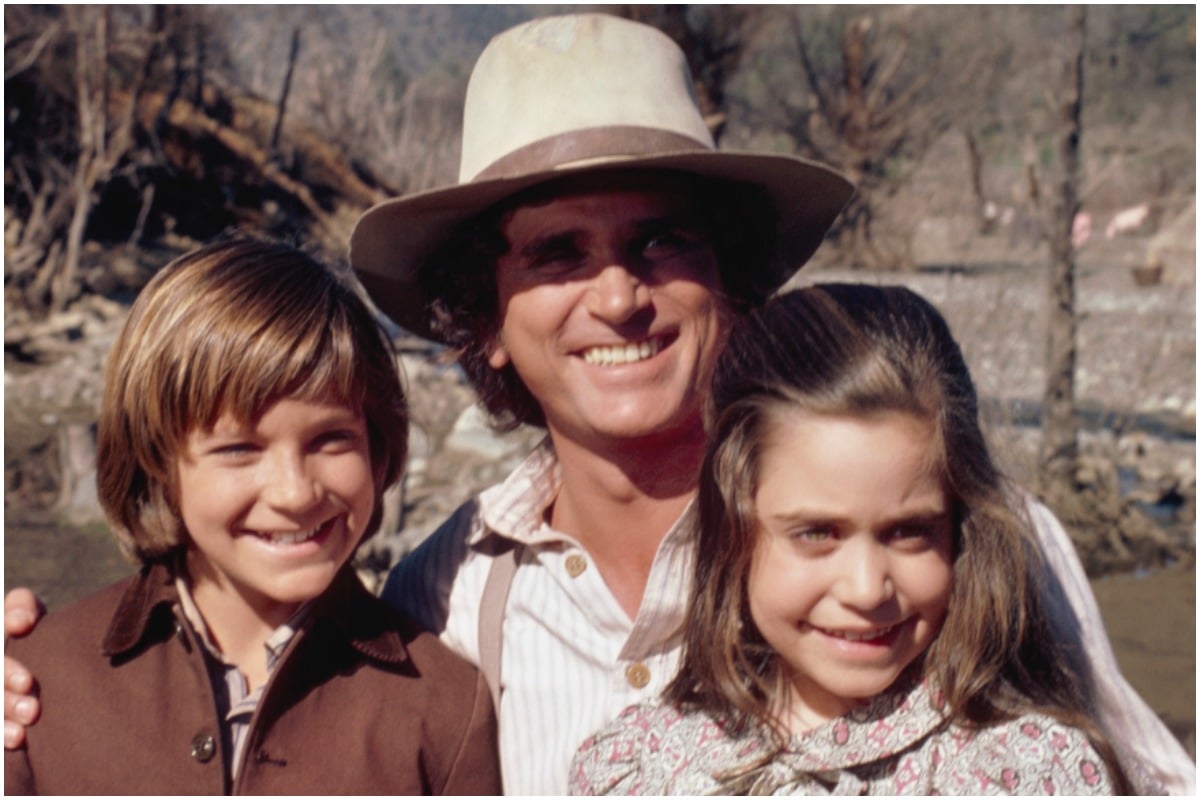 'Little House on the Prairie' star Jason Bateman, Michael Landon, and Melissa Francis smiling outside.