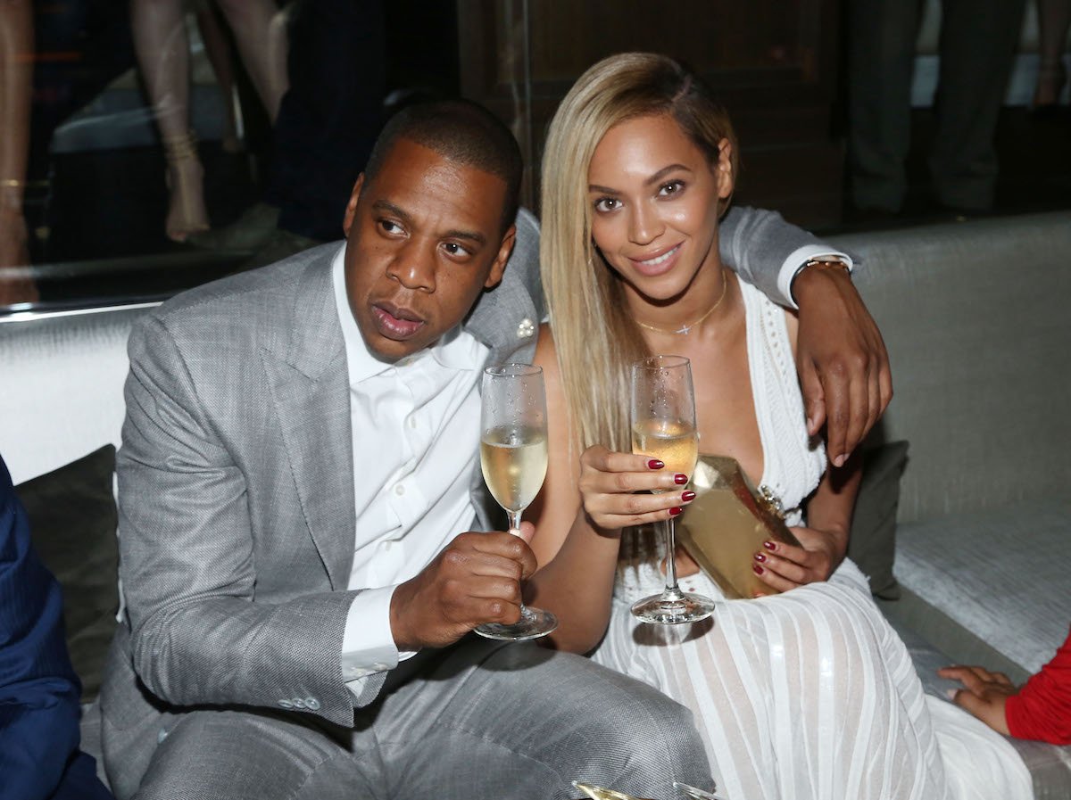 Jay-Z and Beyonce with champagne glasses