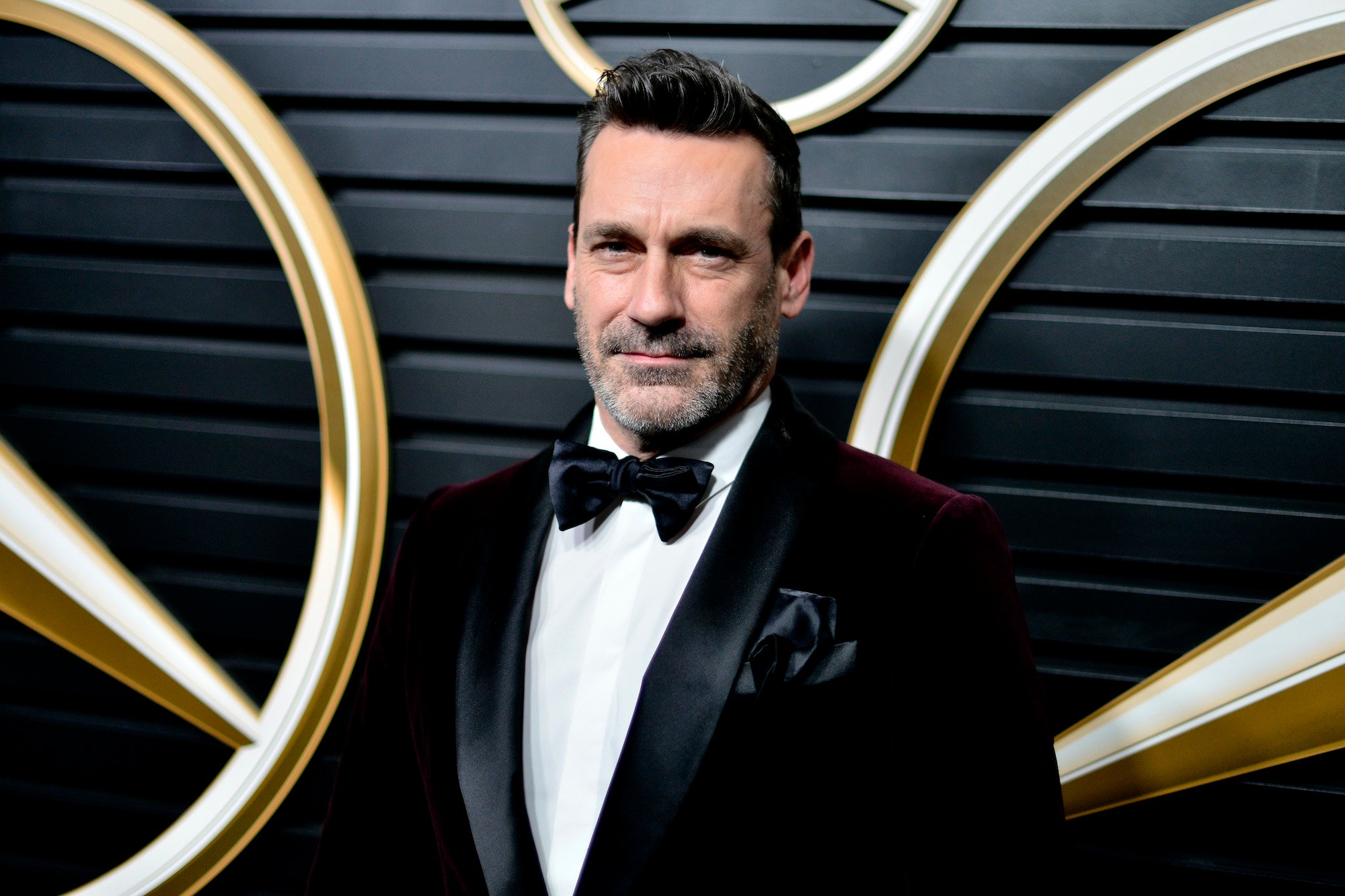 Jon Hamm smiling in a tuxedo