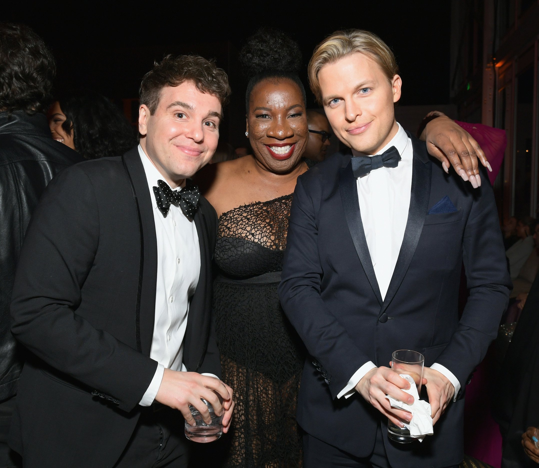 Jon Lovett, Tarana Burke, and Ronan Farrow standing together posing for a photo in black tie attire