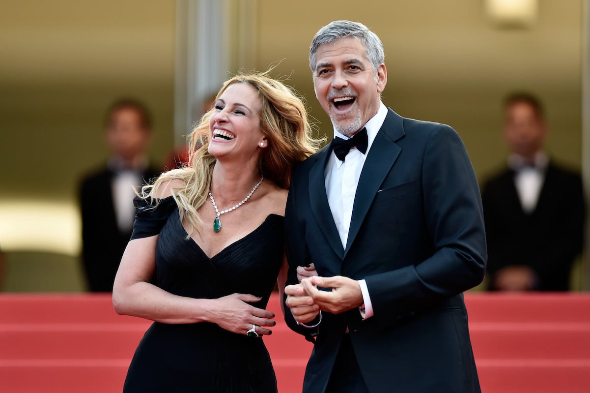 Julia Roberts and George Clooney laugh and smile on the red carpet at the 69th Annual Cannes Film Festival