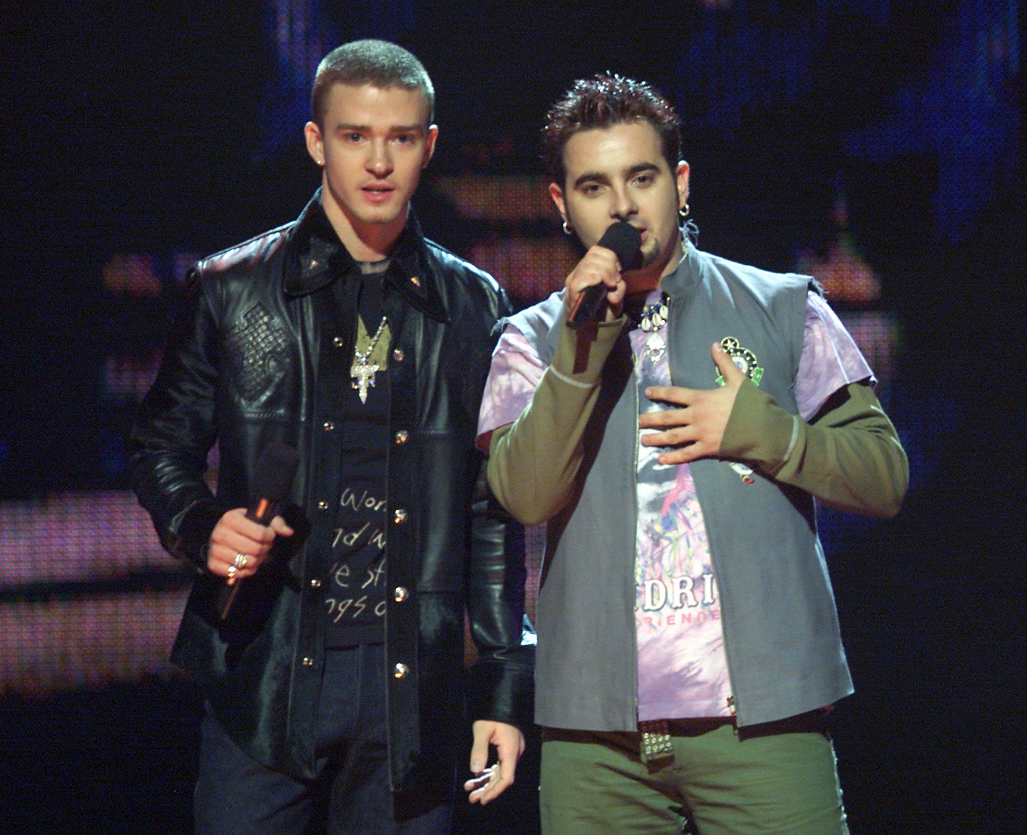 Justin Timberlake and Chris Kirkpatrick of 'NSYNC standing on stage