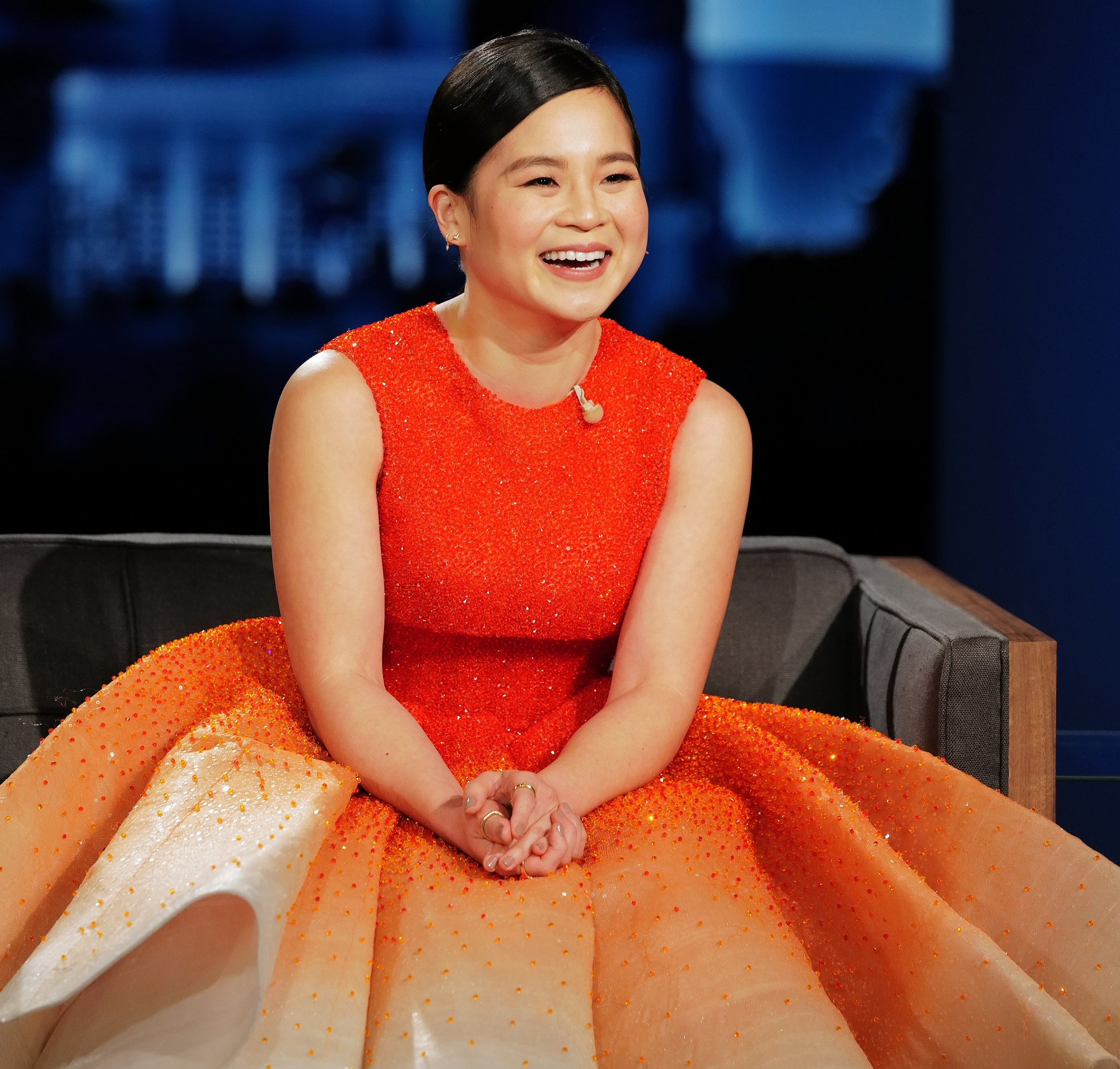 Kelly Marie Tran in an orange dress