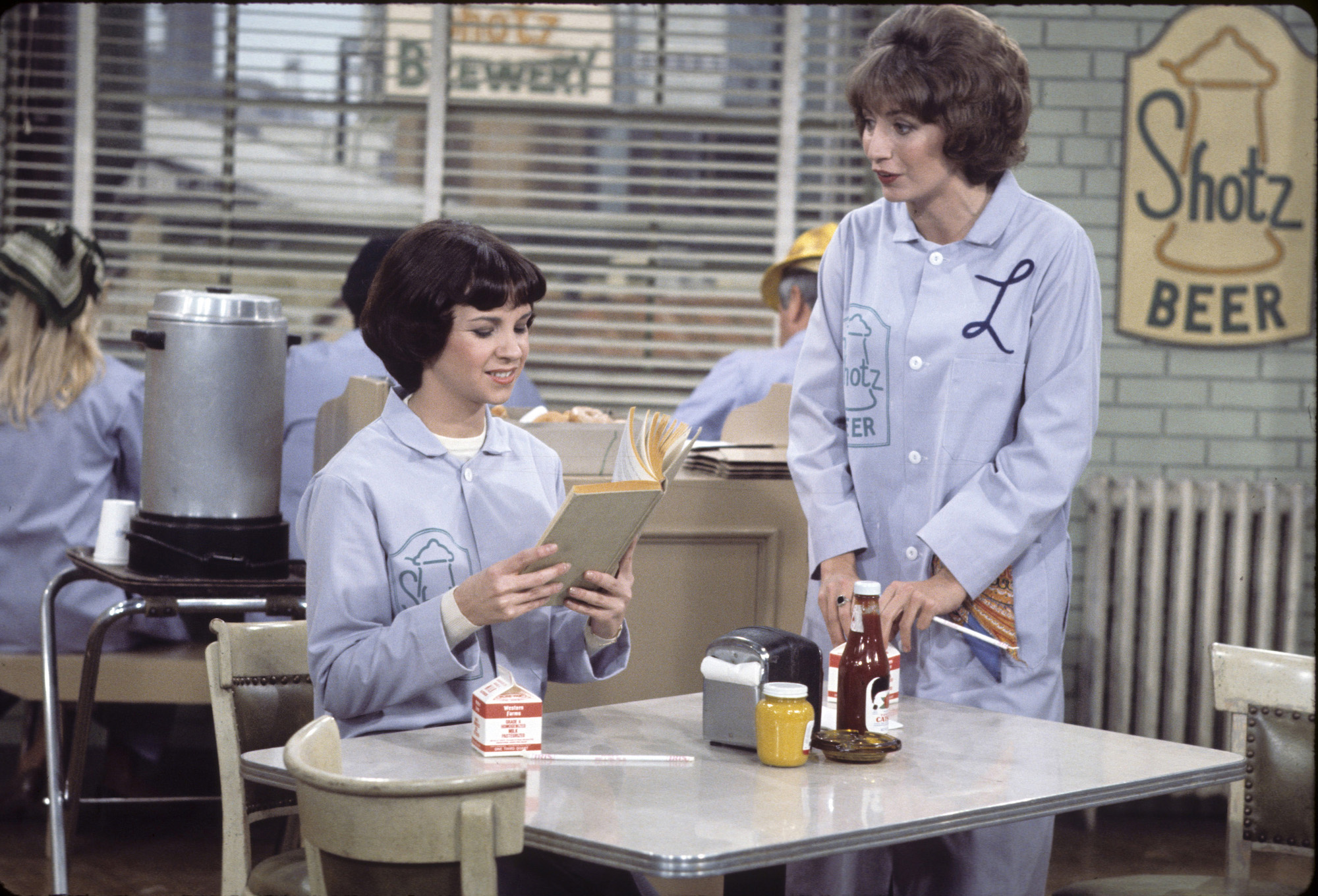 (L-R) Cindy Williams and Penny Marshall on 'Laverne & Shirley' in blue jumpsuits in lunch room