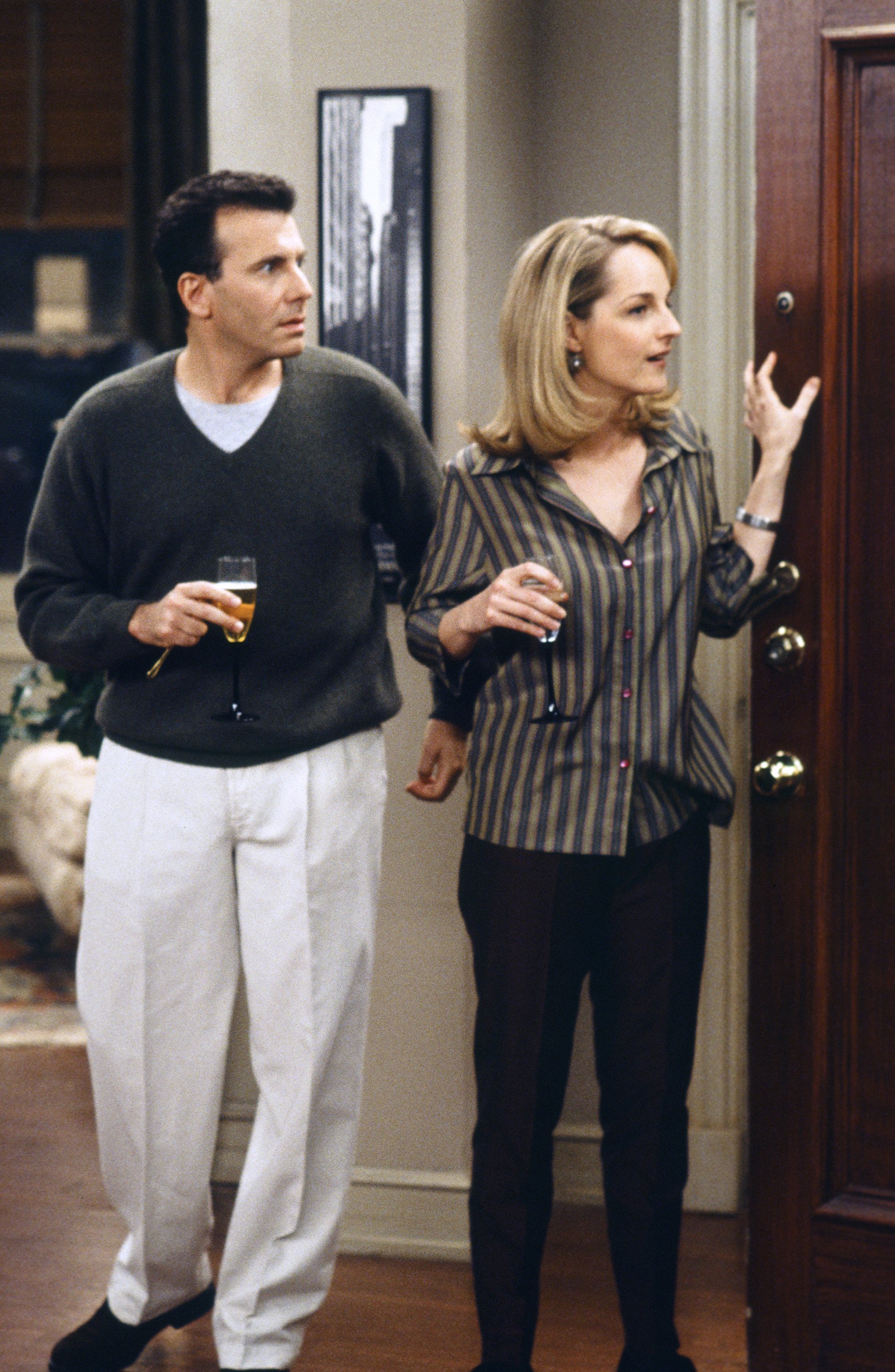 Paul Reiser and Helen Hunt stand on the set of 'Mad About You'