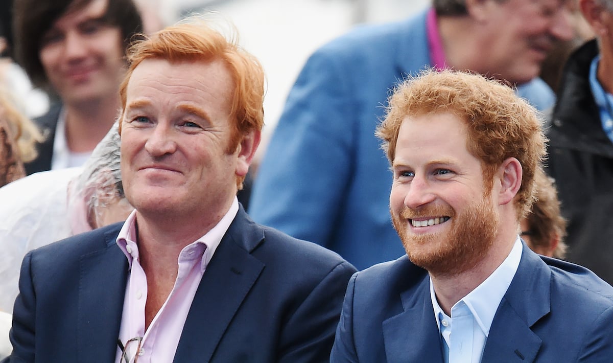Britain's Prince Harry (R), alongside former Royal Equerry Mark Dyer, smiles as he attends the Sentebale Concert at Kensington Palace