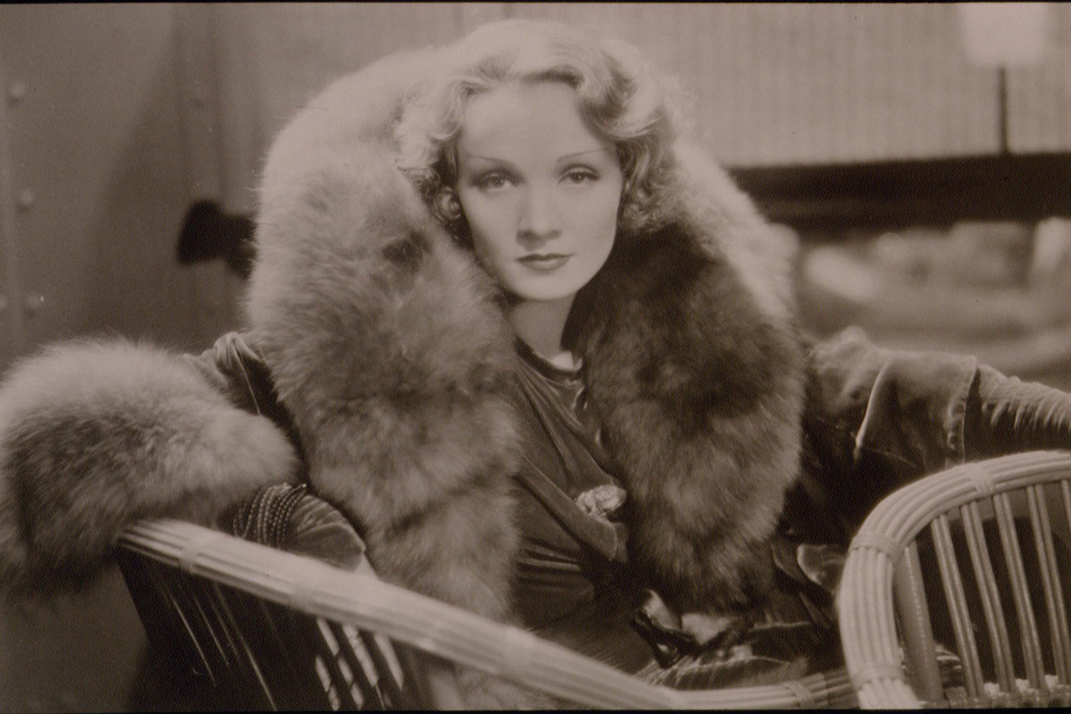 Marlene Dietrich looking at the camera with a large fur collar, in black and white