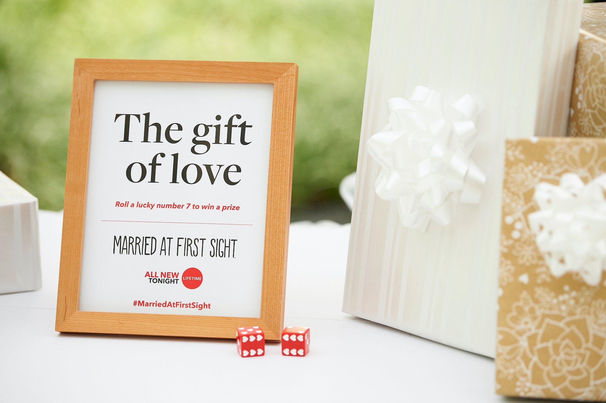 Framed sign with the Married First Sight logo on a table