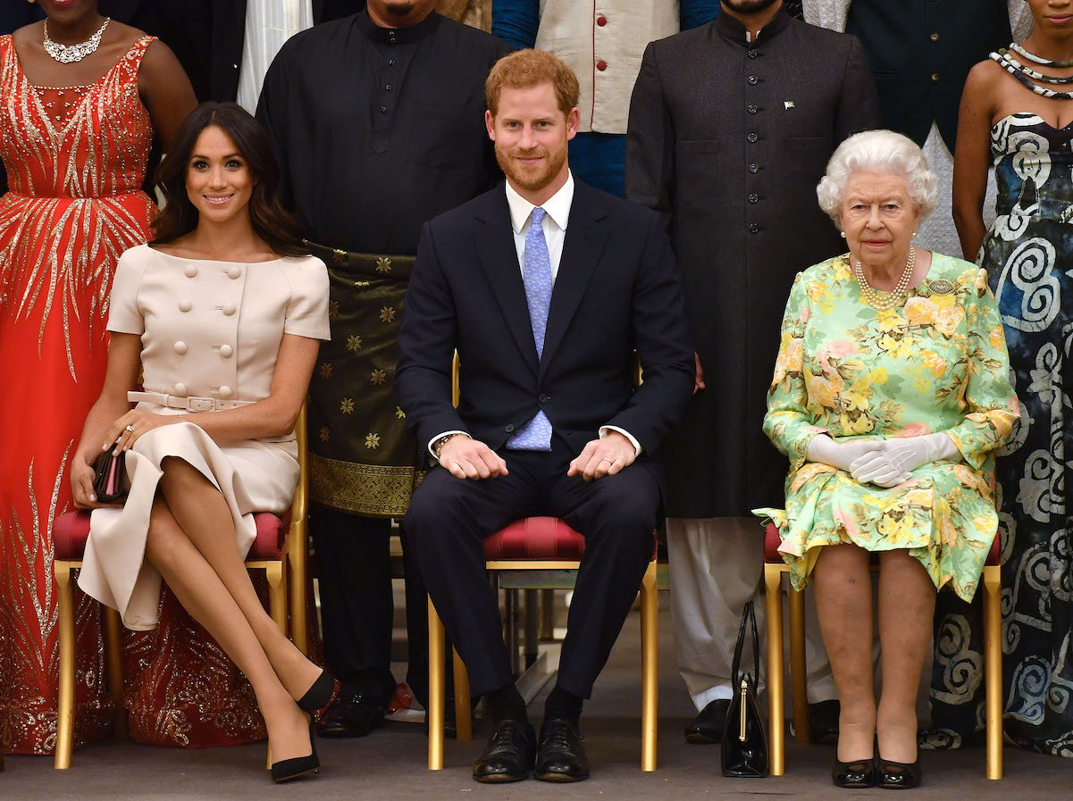 Meghan Markle, Prince Harry, and Queen Elizabeth attend the Queen's Young Leaders Awards Ceremony at Buckingham Palace on June 26, 2018