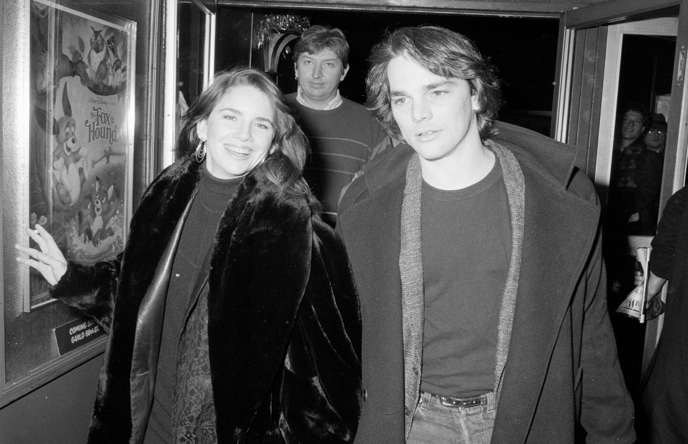 Melissa Gilbert and Bo Brinkman walk down a hallway in black and white