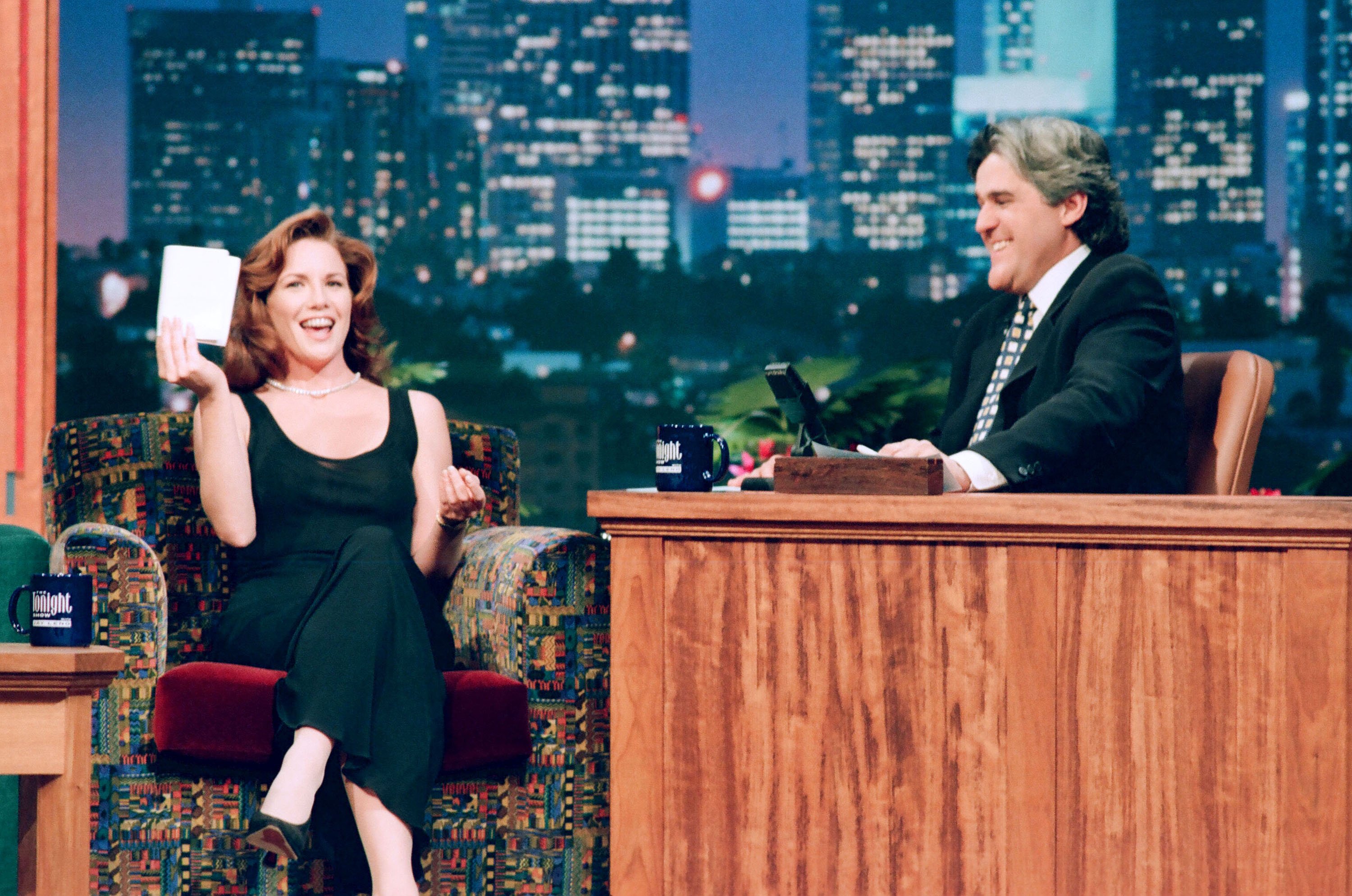 Melissa Gilbert wearing a black dress talking to 'Tonight Show' host Jay Leno.