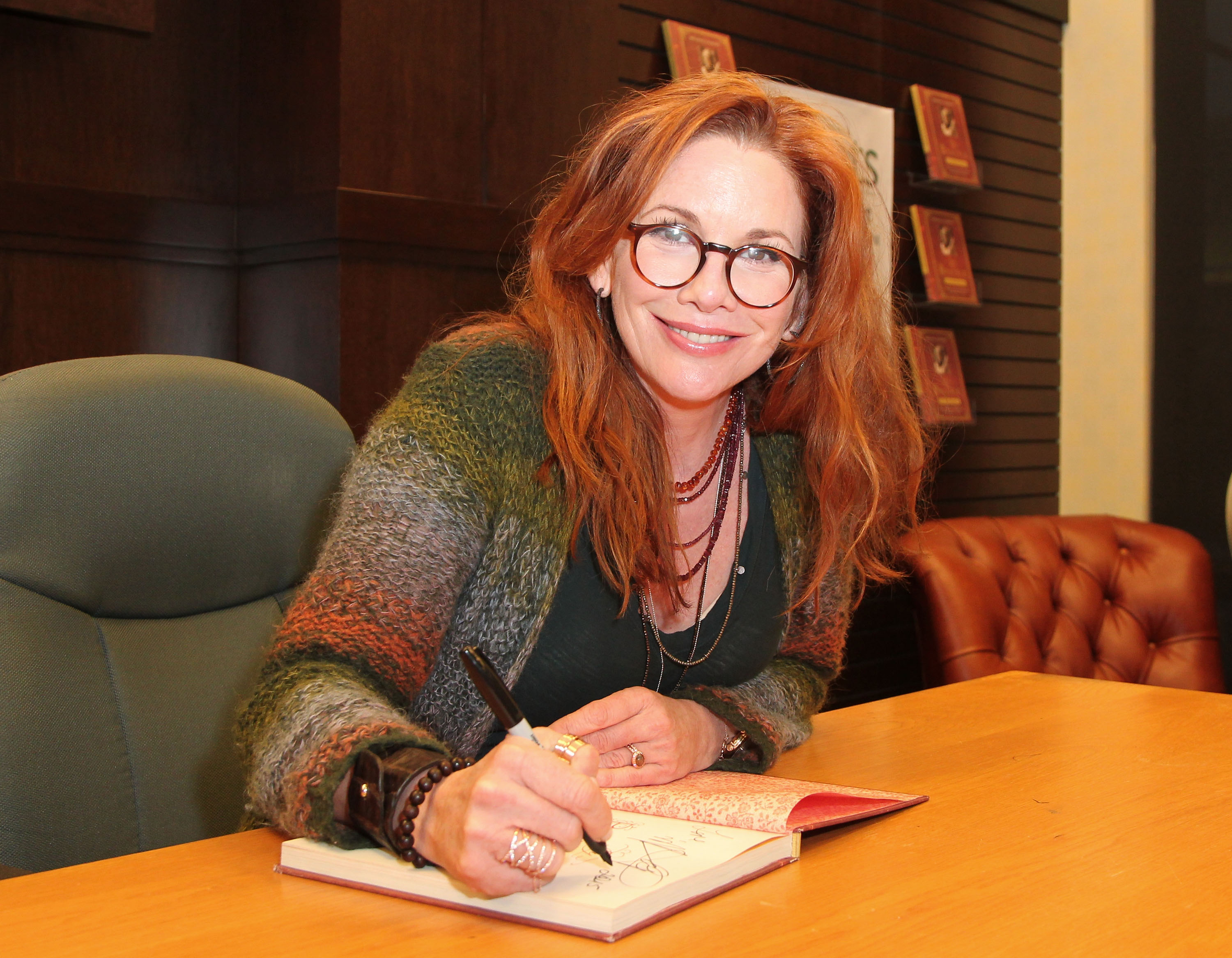 Melissa Gilbert of 'Little House on the Prairie' signs copies of her book 'My Prairie Cookbook' at Barnes & Noble bookstore at The Grove 