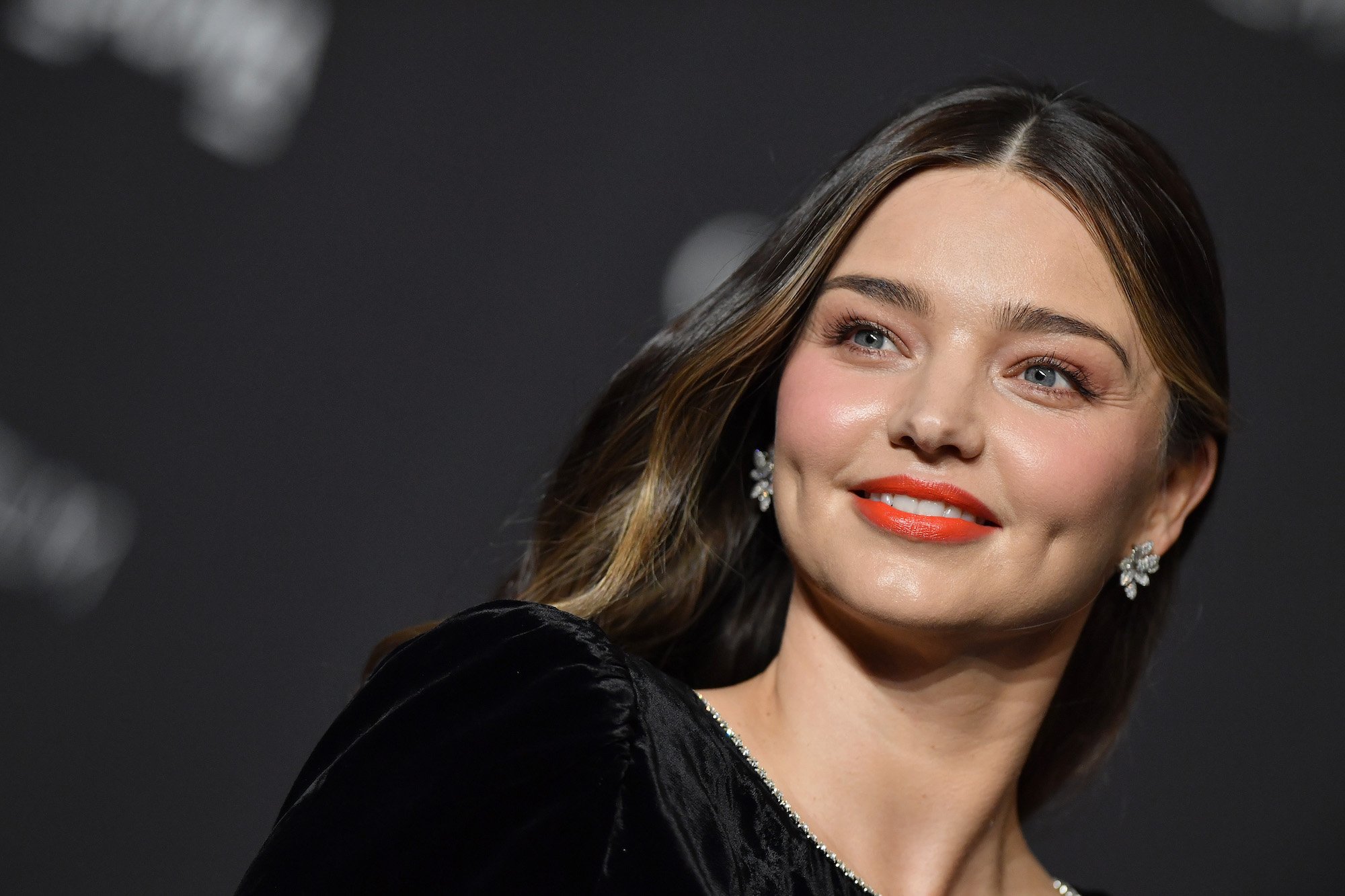 Miranda Kerr smiling, looking to the left