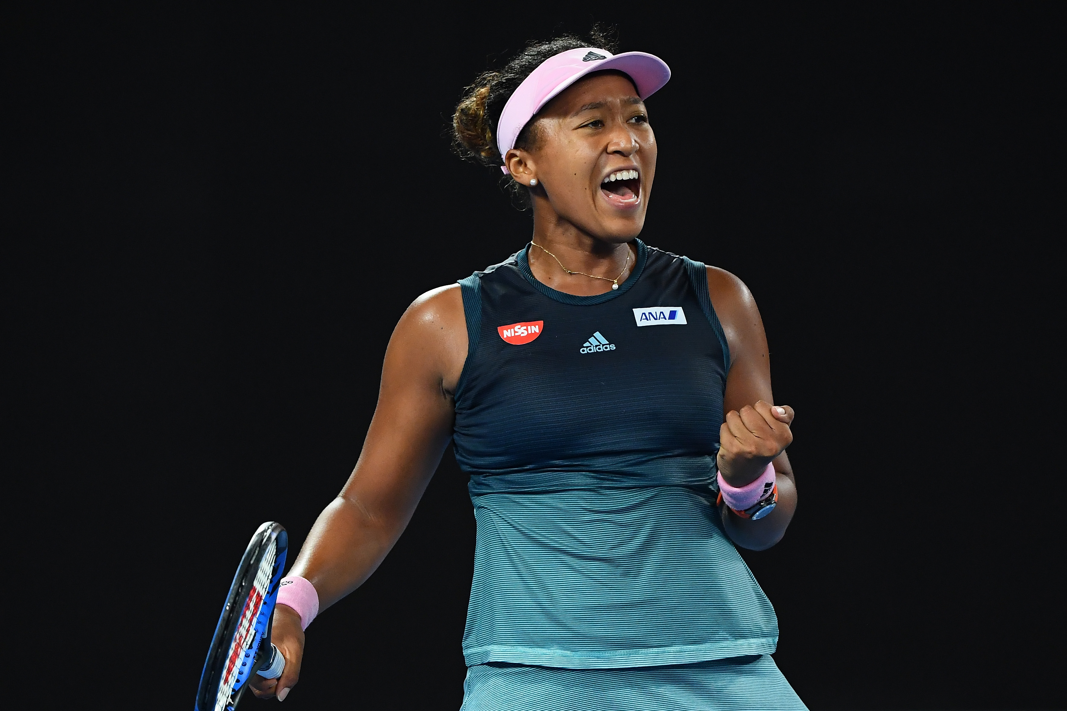 Naomi Osaka celebrates win after match in 2019