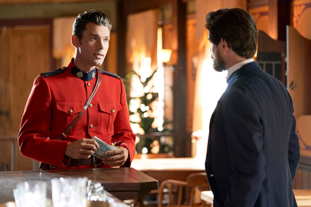 Kevin McGarry as Nathan Grant, wearing a red jacket and talking to another man, in 'When Calls the Heart' 