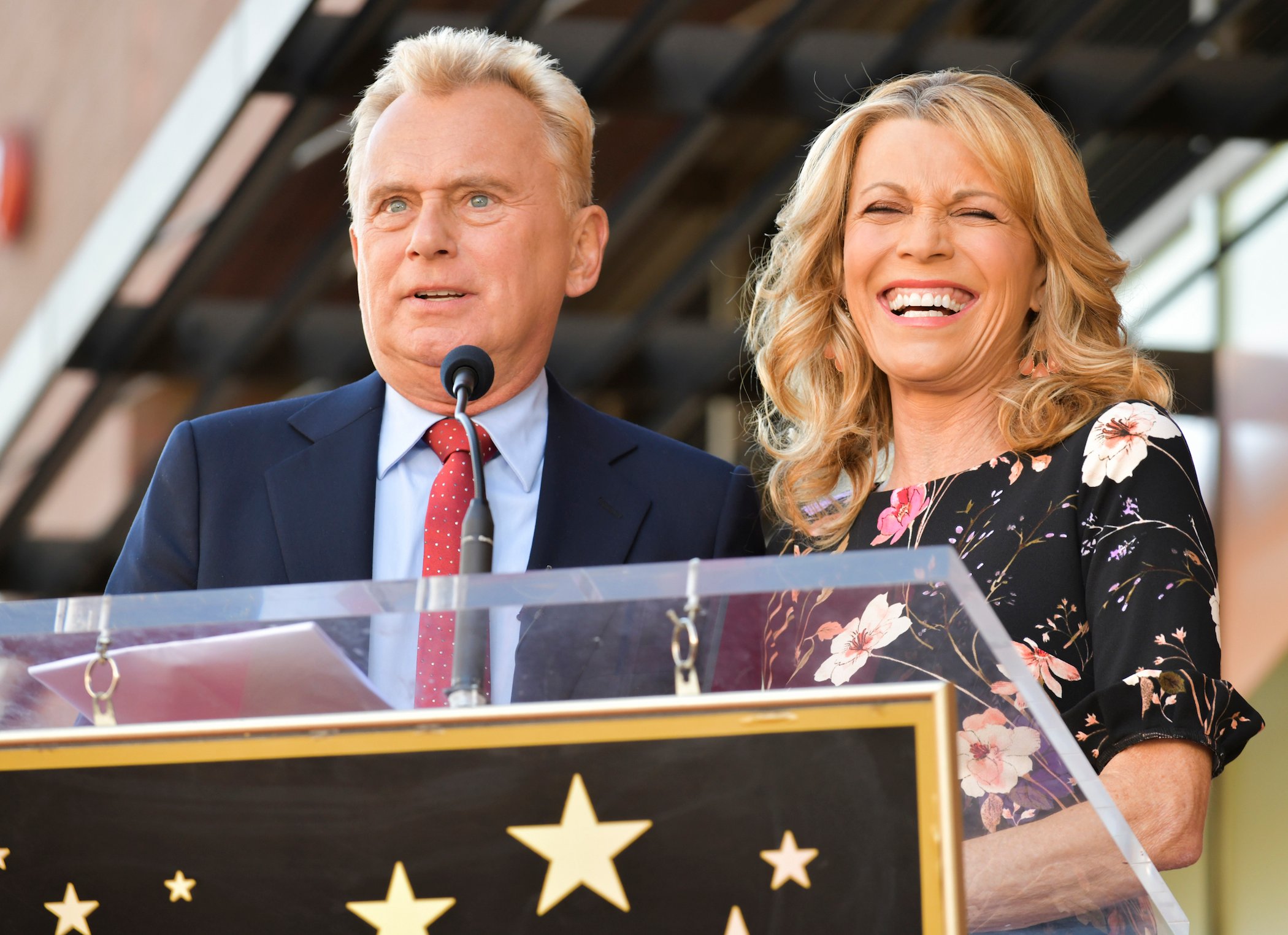 Pat Sajak and Vanna White from 'Wheel of Fortune' smiling at the Hollywood Walk of Fame
